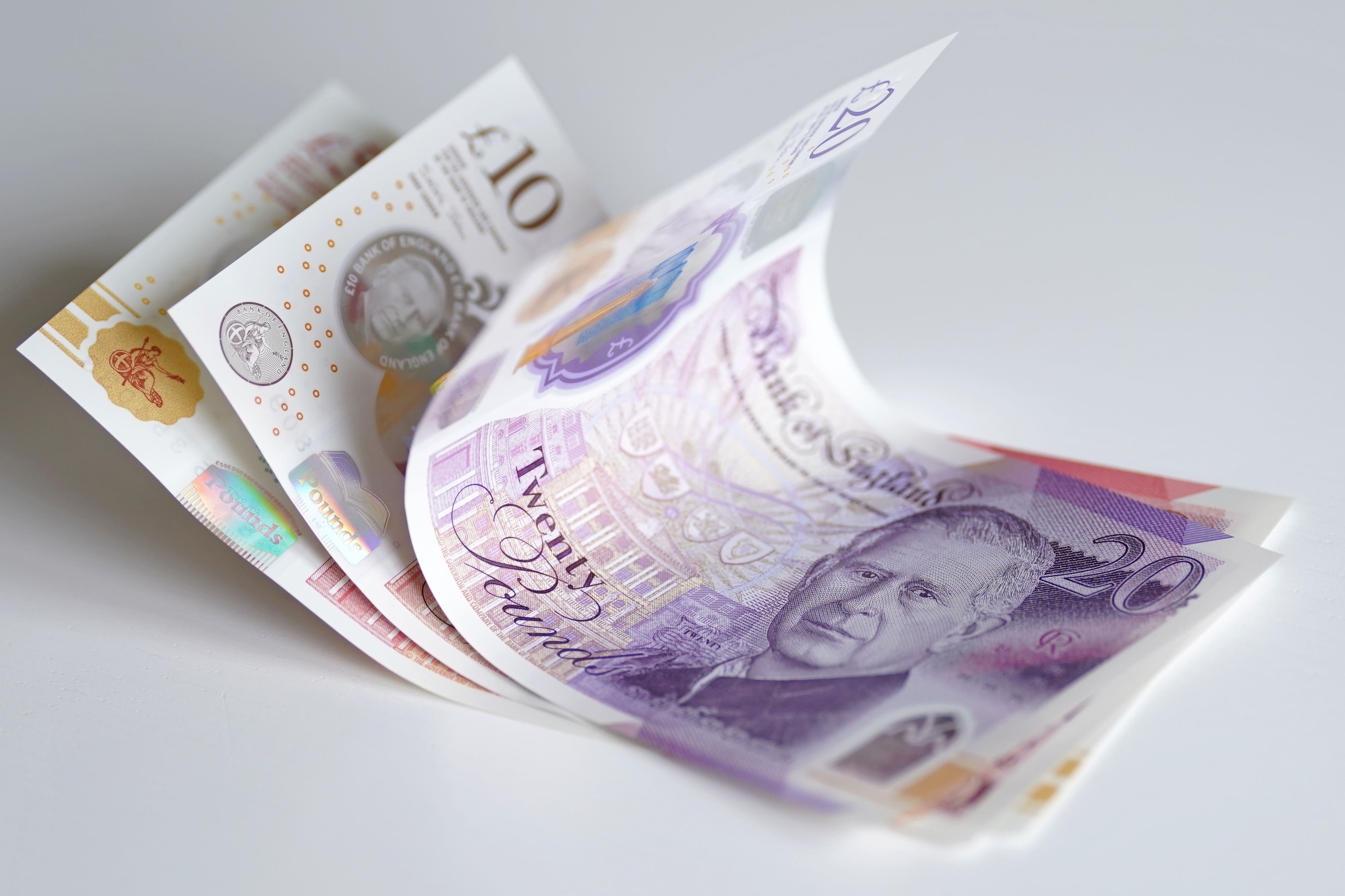 A view of bank notes, £5, £10, £20 and £50 issued by the Bank of England featuring a portrait of the King (PA)