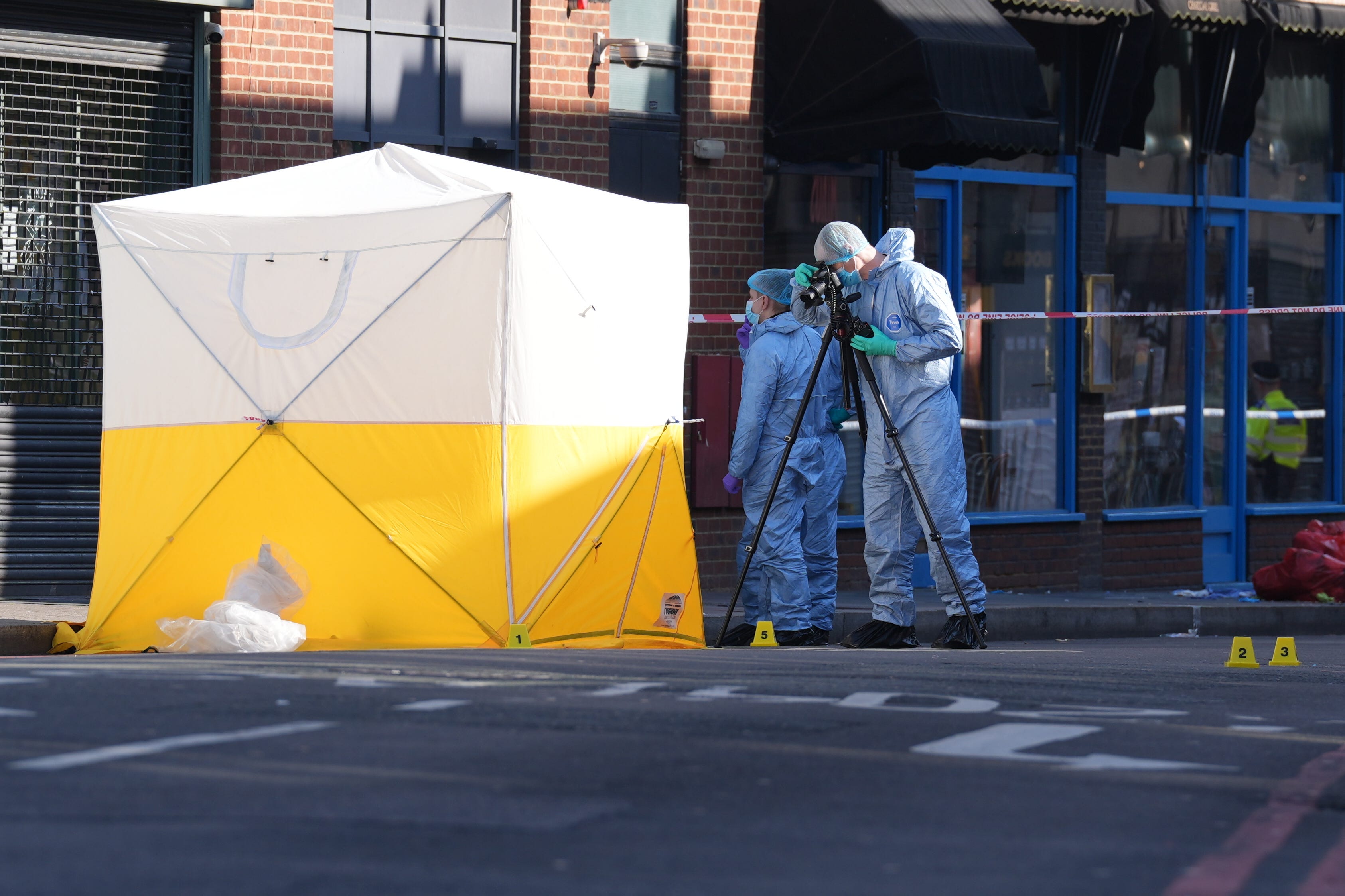 Forensic officers at the scene in Brixton Road, Lambeth, after the man died (Lucy North/PA)