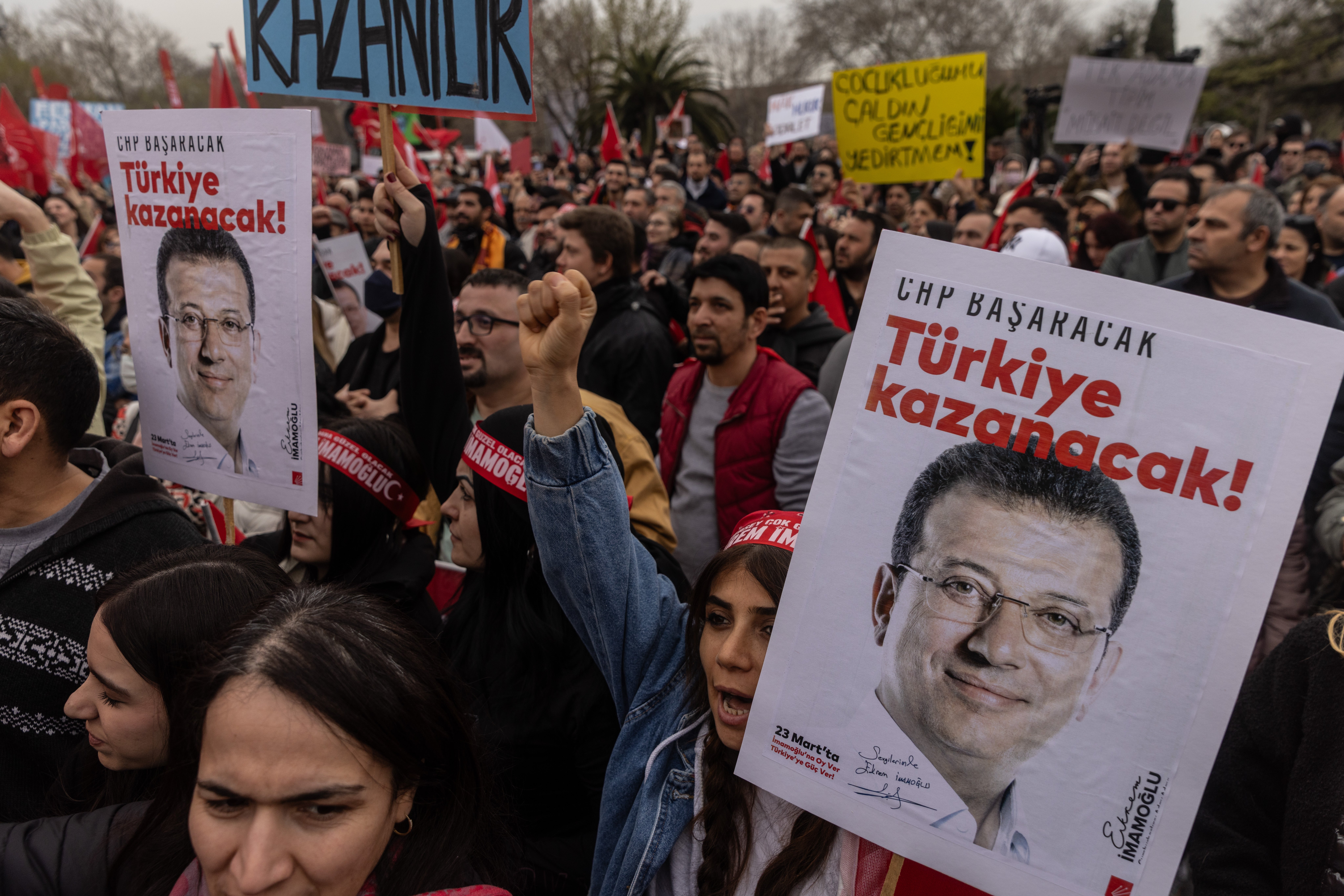 Demonstrators chant slogans as they hold posters in support of arrested Istanbul Mayor Ekrem Imamoglu on Sunday