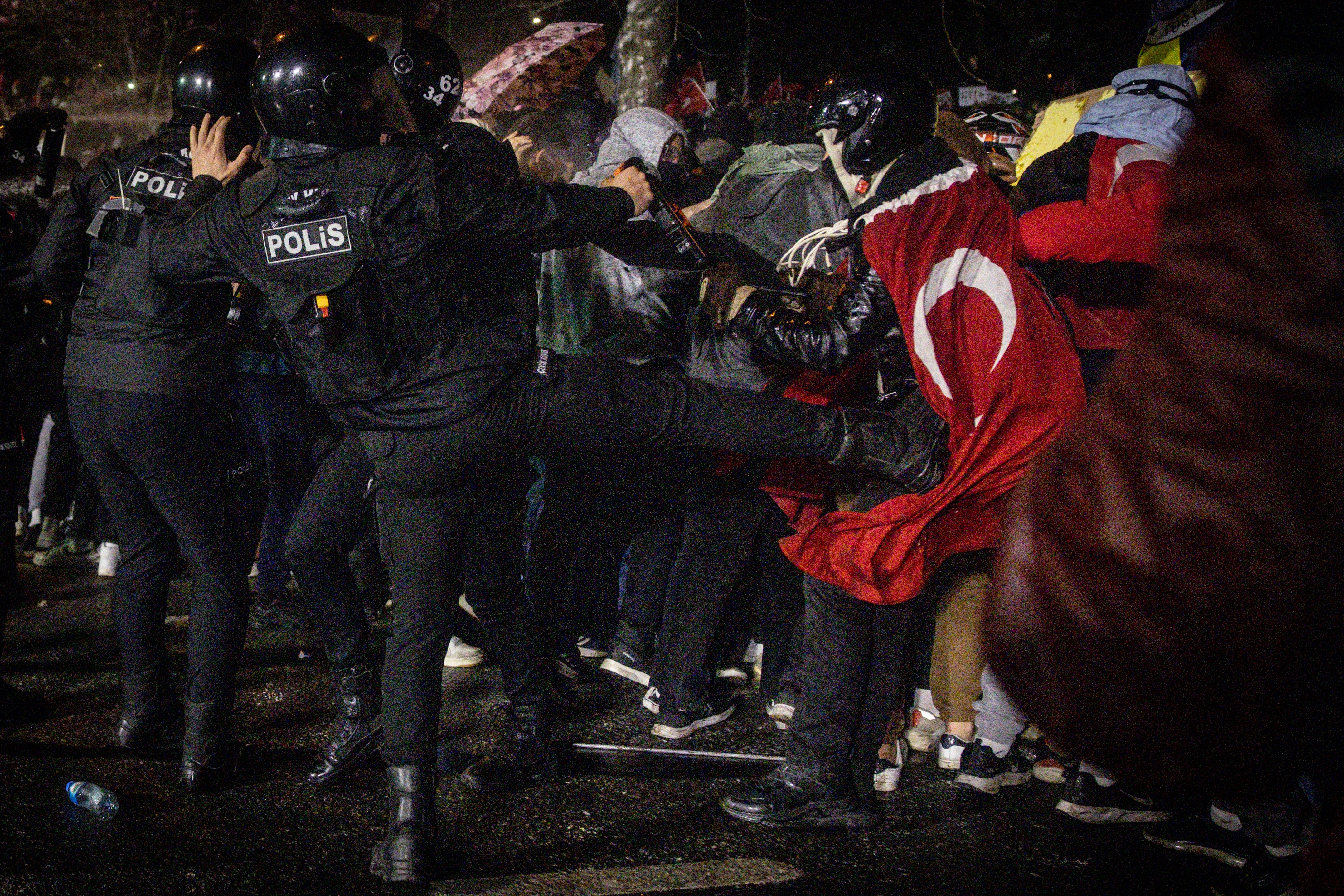 A police officer appears to kick a protester during clashes in front of Istanbul's famous Aquaduct on the weekend