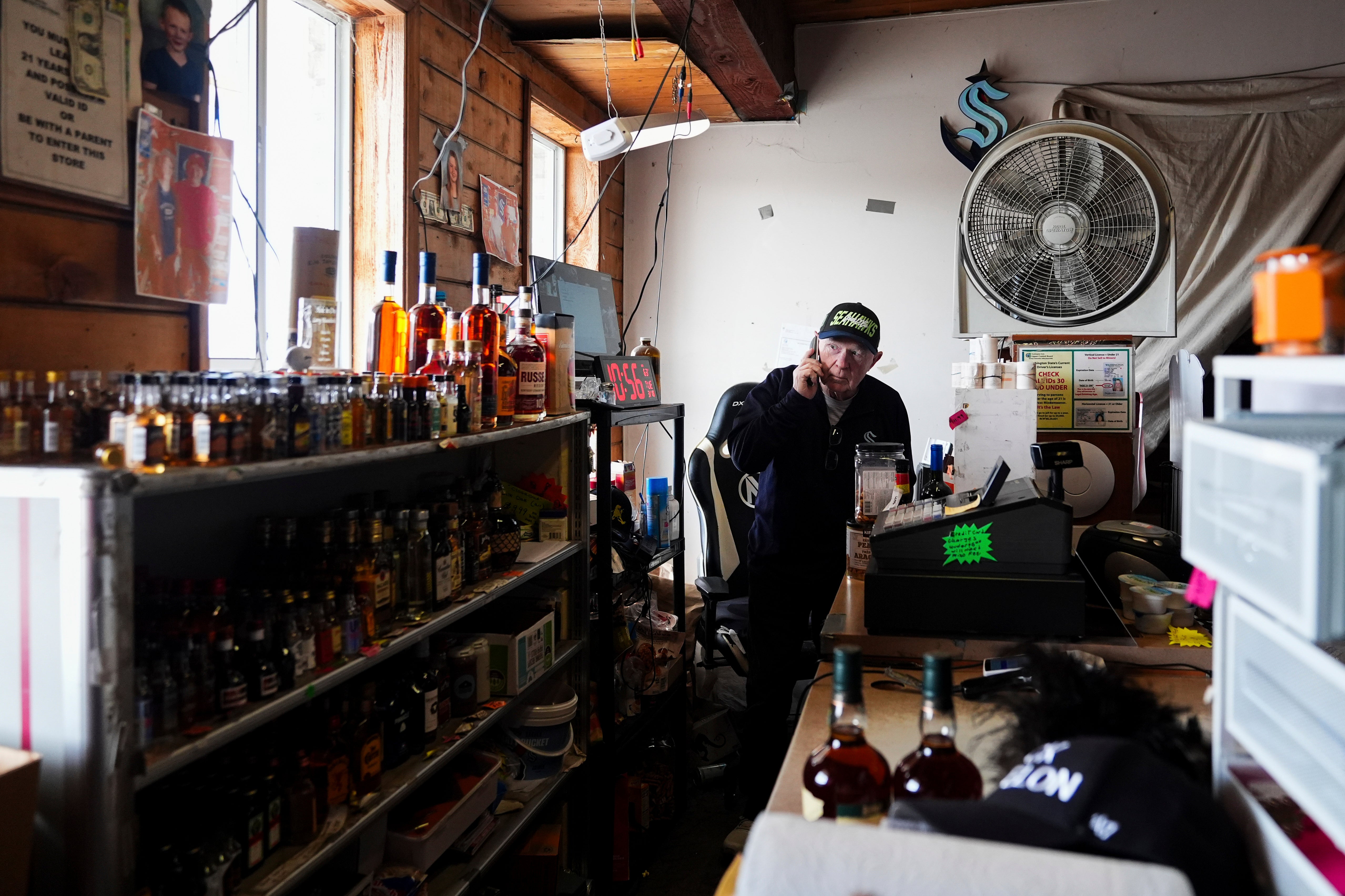 Larry Musselwhite, owner of Larry's Liquor Locker, answers a call from a Canadian citizen asking if they can still buy alcohol from his store and bring it back to Canada