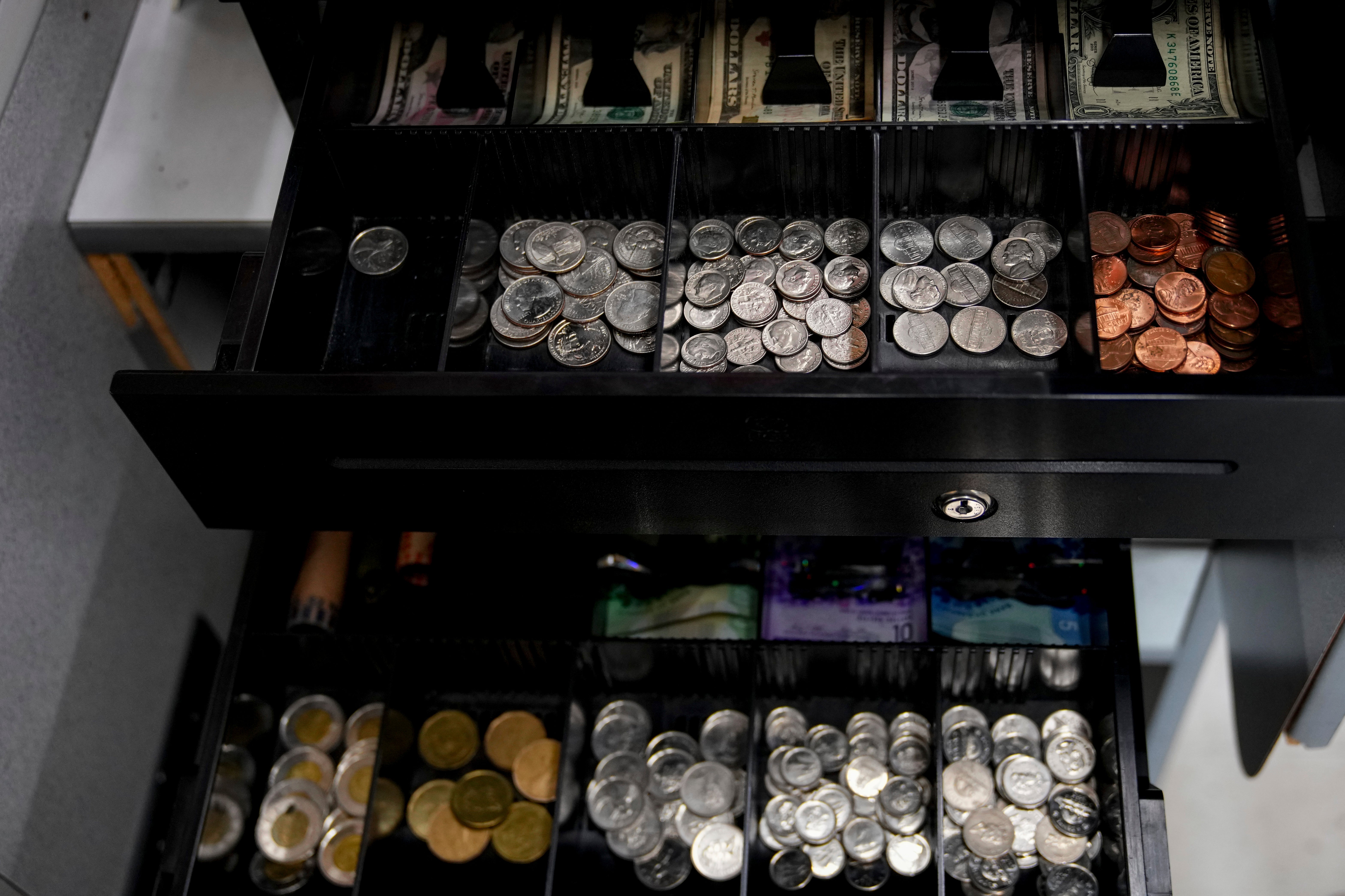 Trays for both American and Canadian money at the Point Roberts International Marketplace