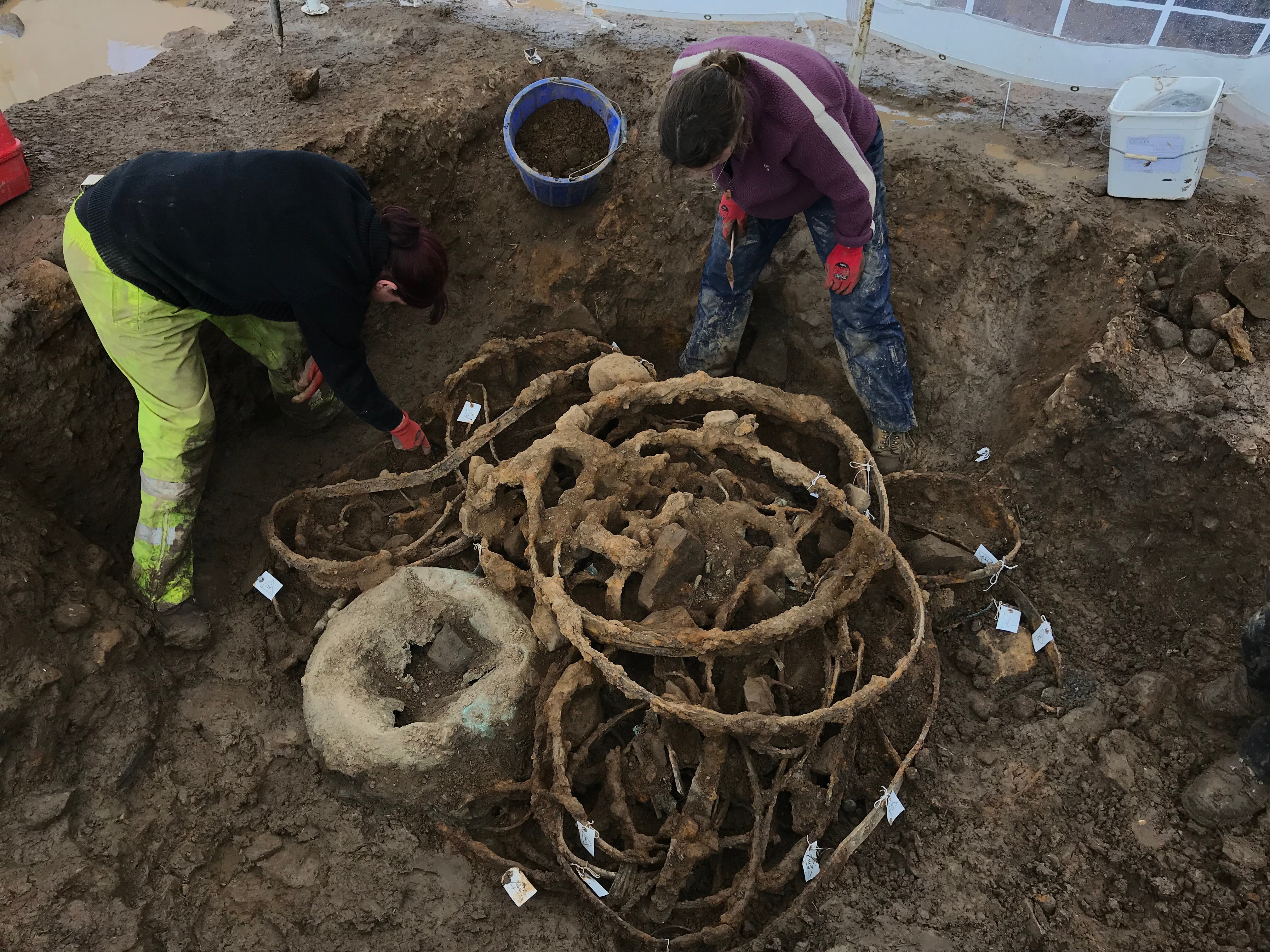 The bent iron tyres and cauldron at the excavation site