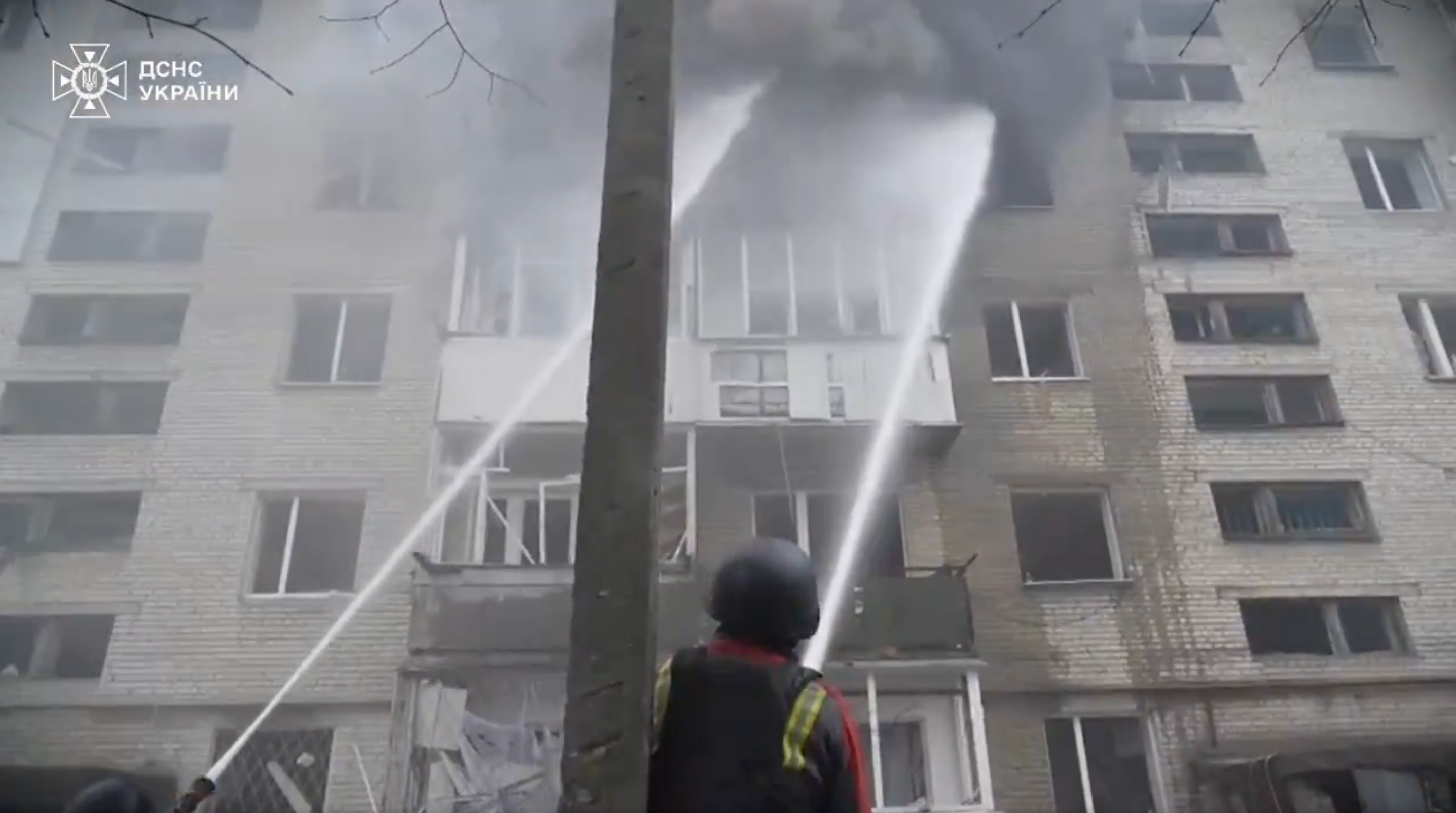 Firefighters tackle a blaze in a residential building in Sumy on Monday