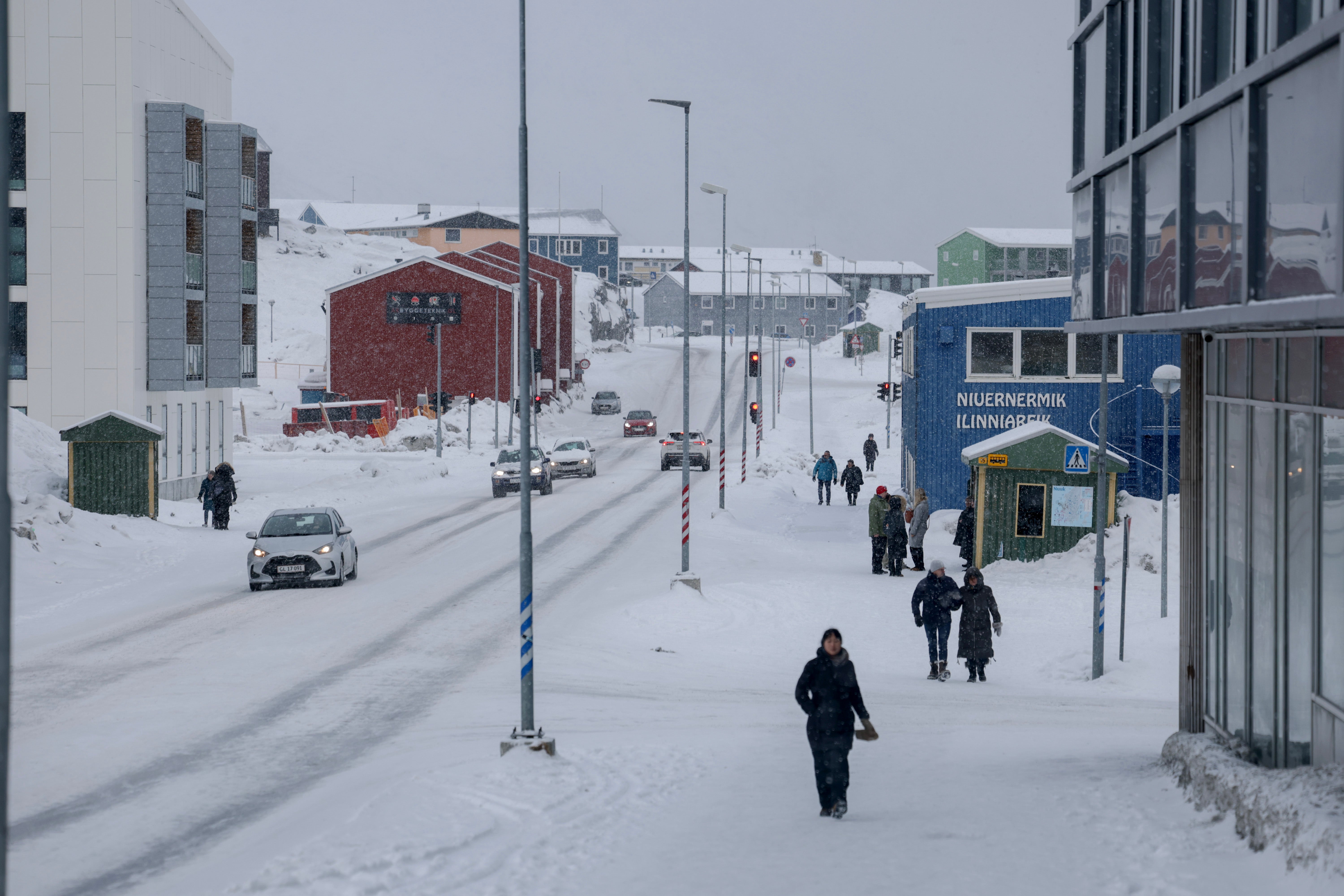 President Donald Trump says he wants Greenland for ‘national security’ purposes. He’d be getting a melting island. Pedestrians walk along a street on March 14, 2025 in Nuuk, Greenland