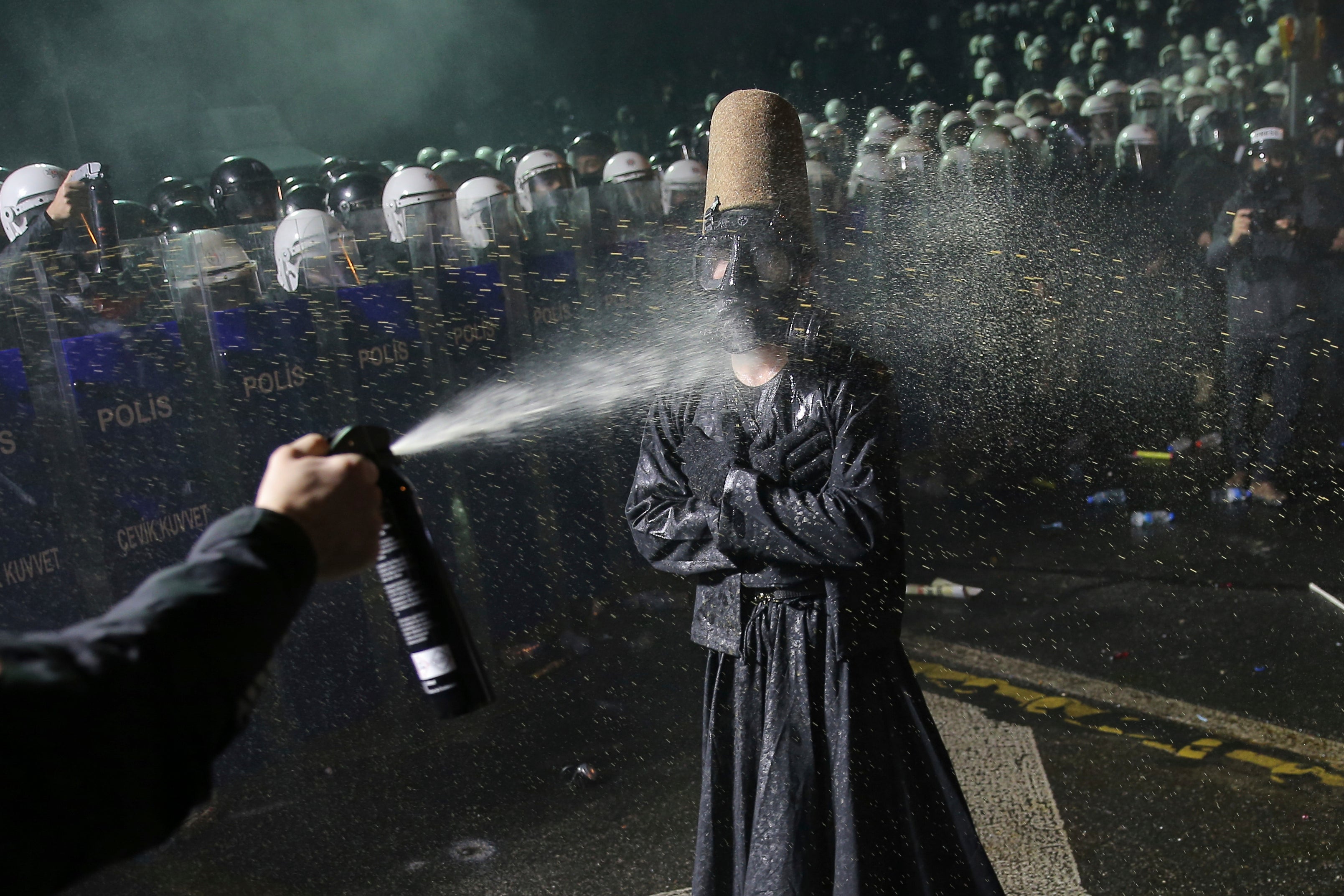 Riot police officers use pepper spray to clear a protester during a protest after Istanbul's Mayor Ekrem Imamoglu was arrested and sent to prison