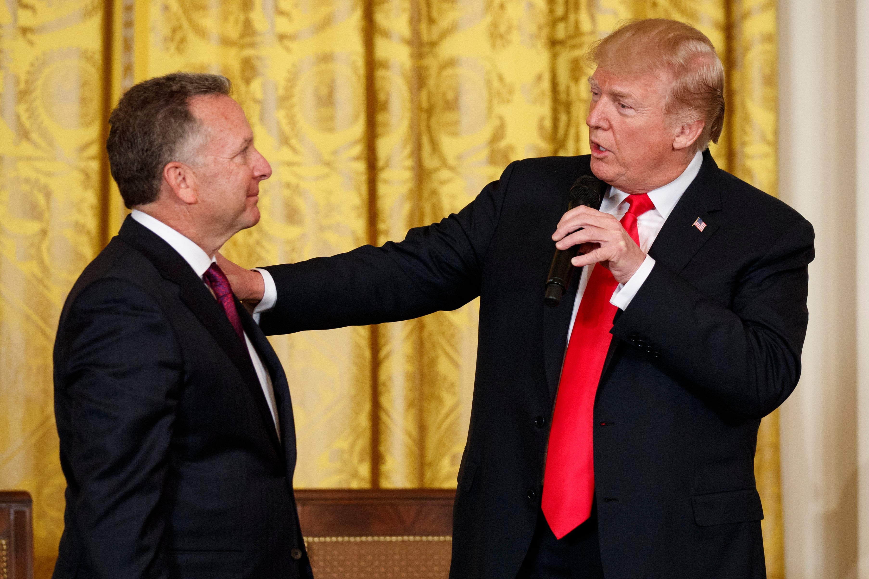 Donald Trump speaks to businessman and now peace envoy Steve Witkoff during a meeting in the White House in 2018