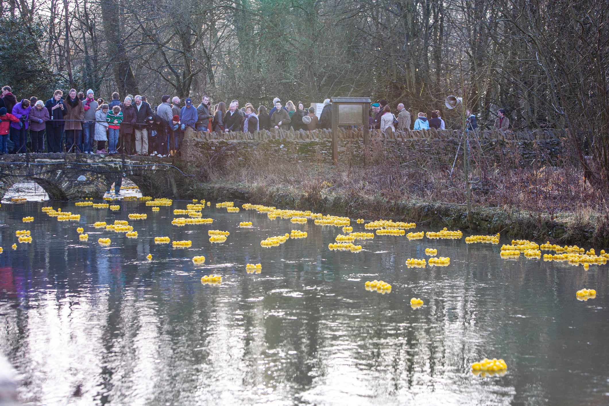 Crowds of people attend the annual duck race in Bibury, another draw of attraction for the small village