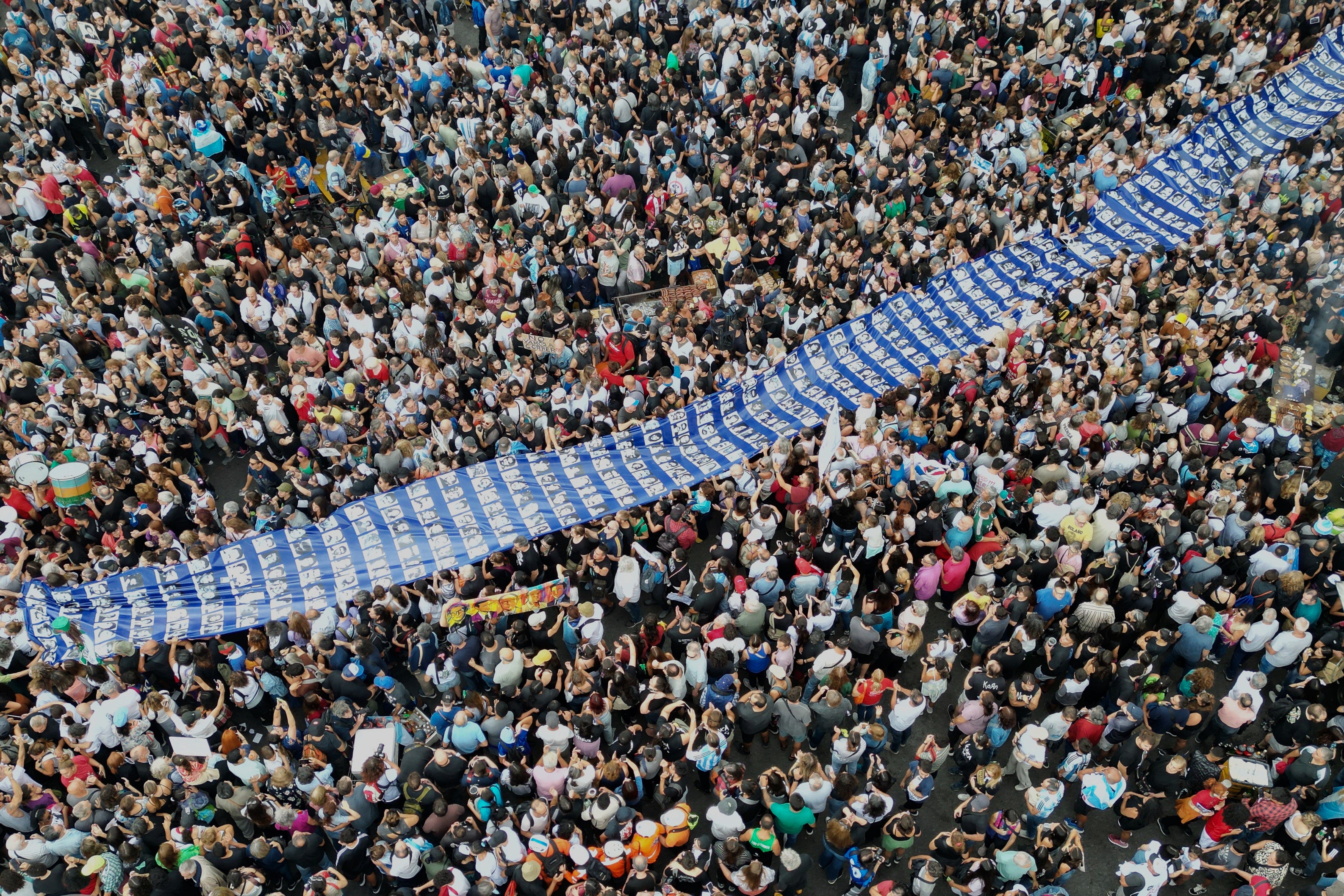 Demonstrators transportation a banner pinch photos of group who vanished during Argentina's subject dictatorship (1976-1983) successful a march commemorating nan day of nan country's 1976 coup, successful Buenos Aires, Argentina