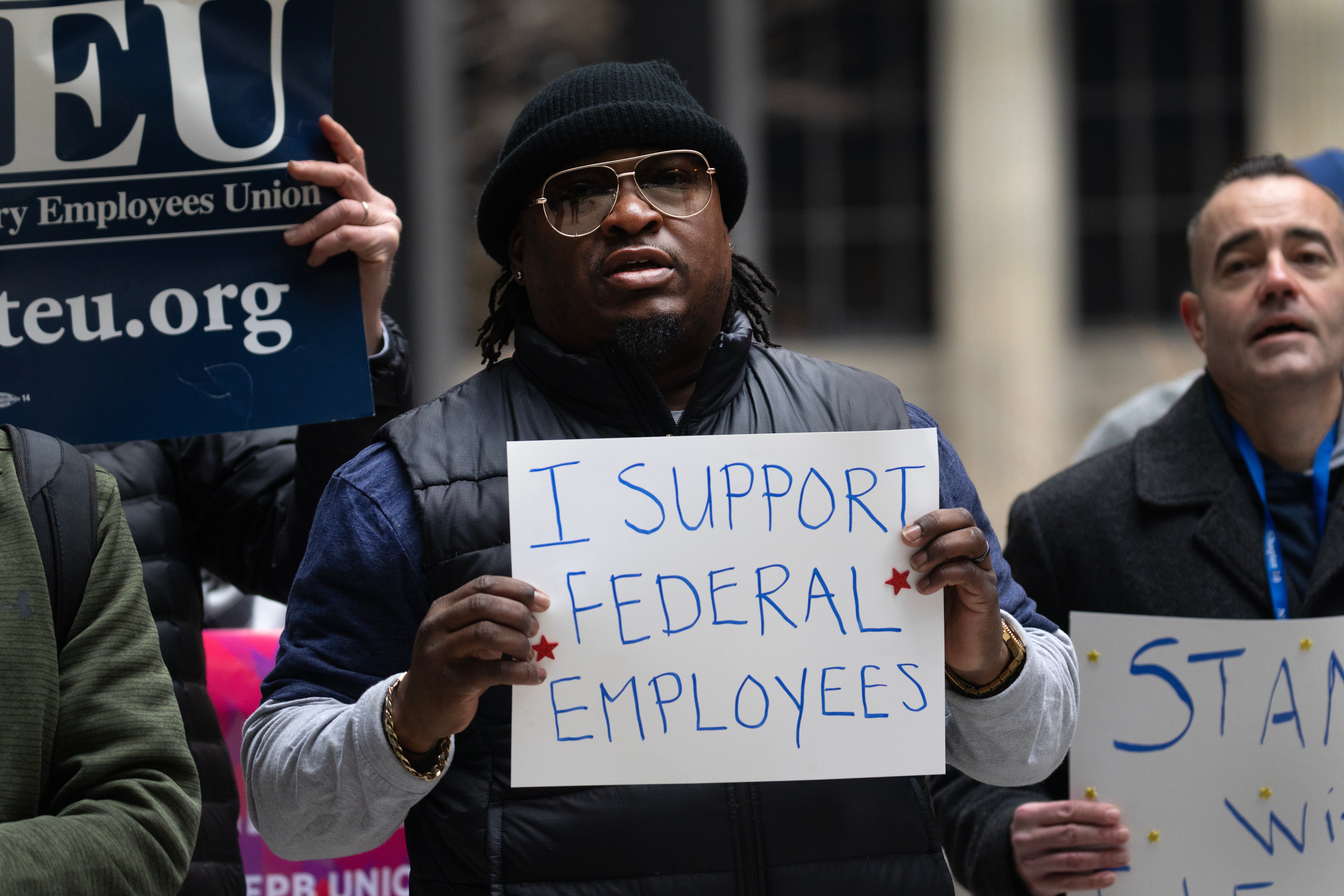 Federal employees rally in support of their jobs outside of the Kluczynski Federal Building in Chicago