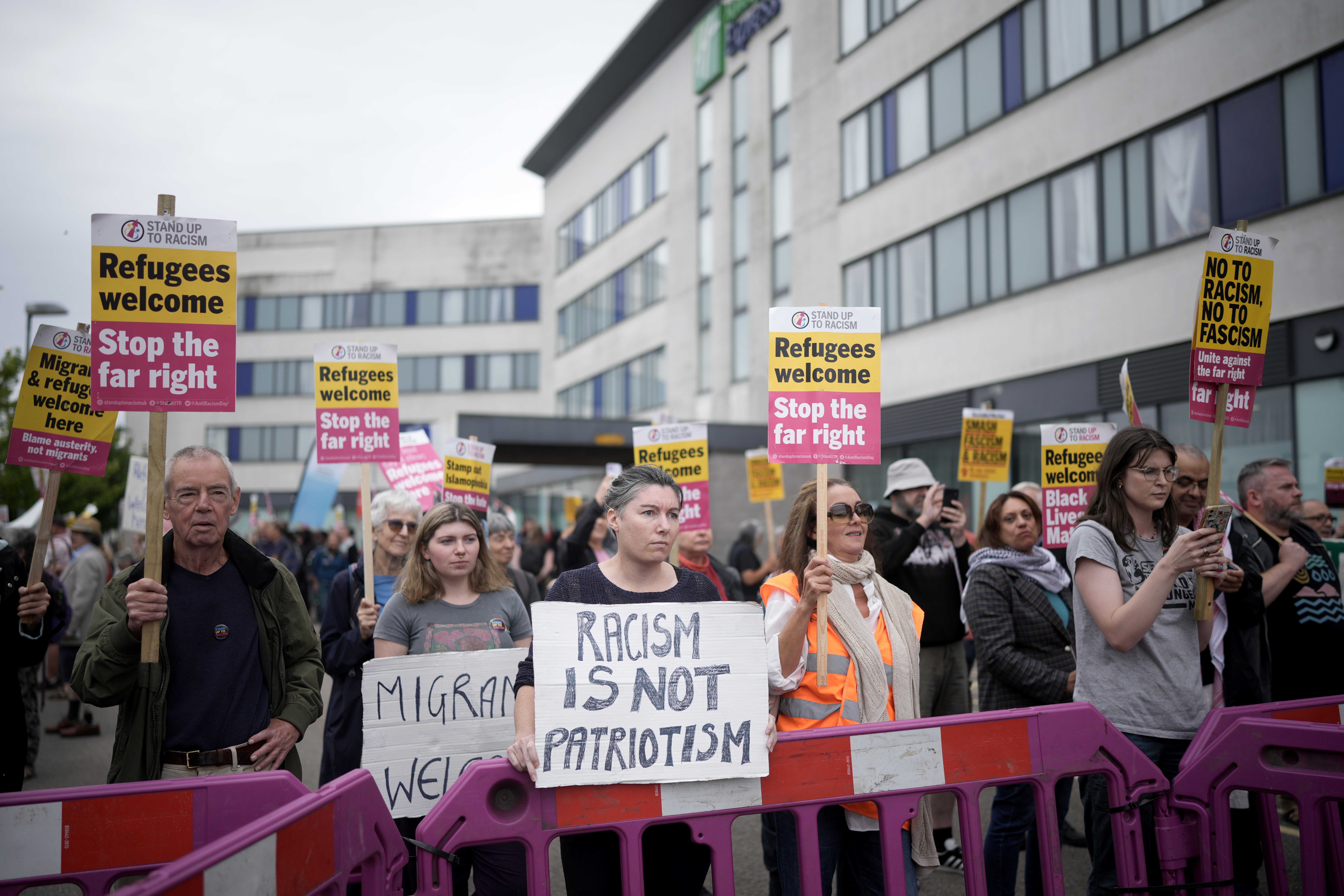 Anti-racism counter protesters hold placards outside of the Holiday Inn Express in Manvers, which is being used as an asylum hotel, on August 4, 2024 in Rotherham, after anti-migrant violence erupted across England