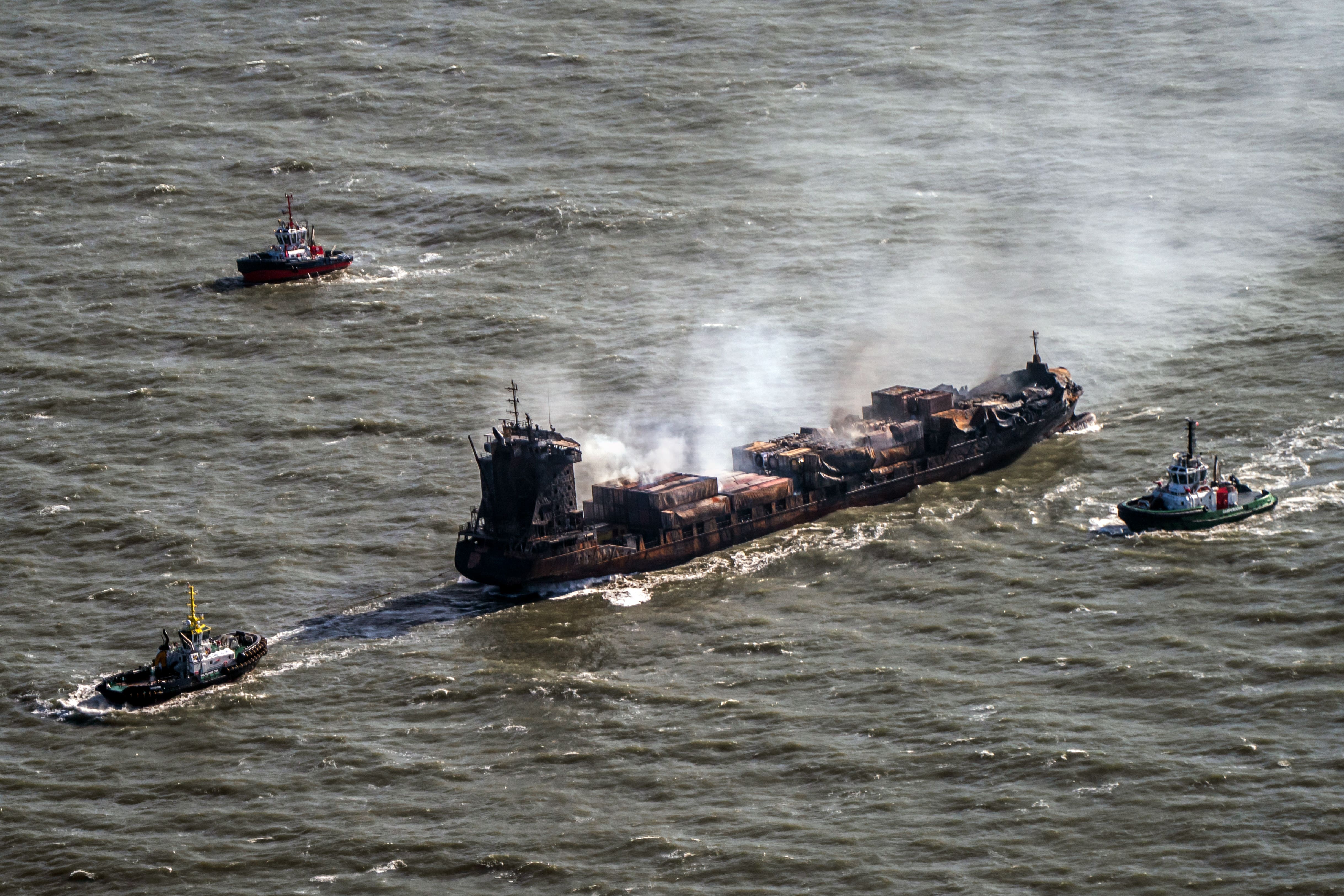 Tug boats shadow the Solong container ship as it drifts in the Humber Estuary, off the coast of East Yorkshire, following a collision with the MV Stena Immaculate oil tanker (Danny Lawson/PA)