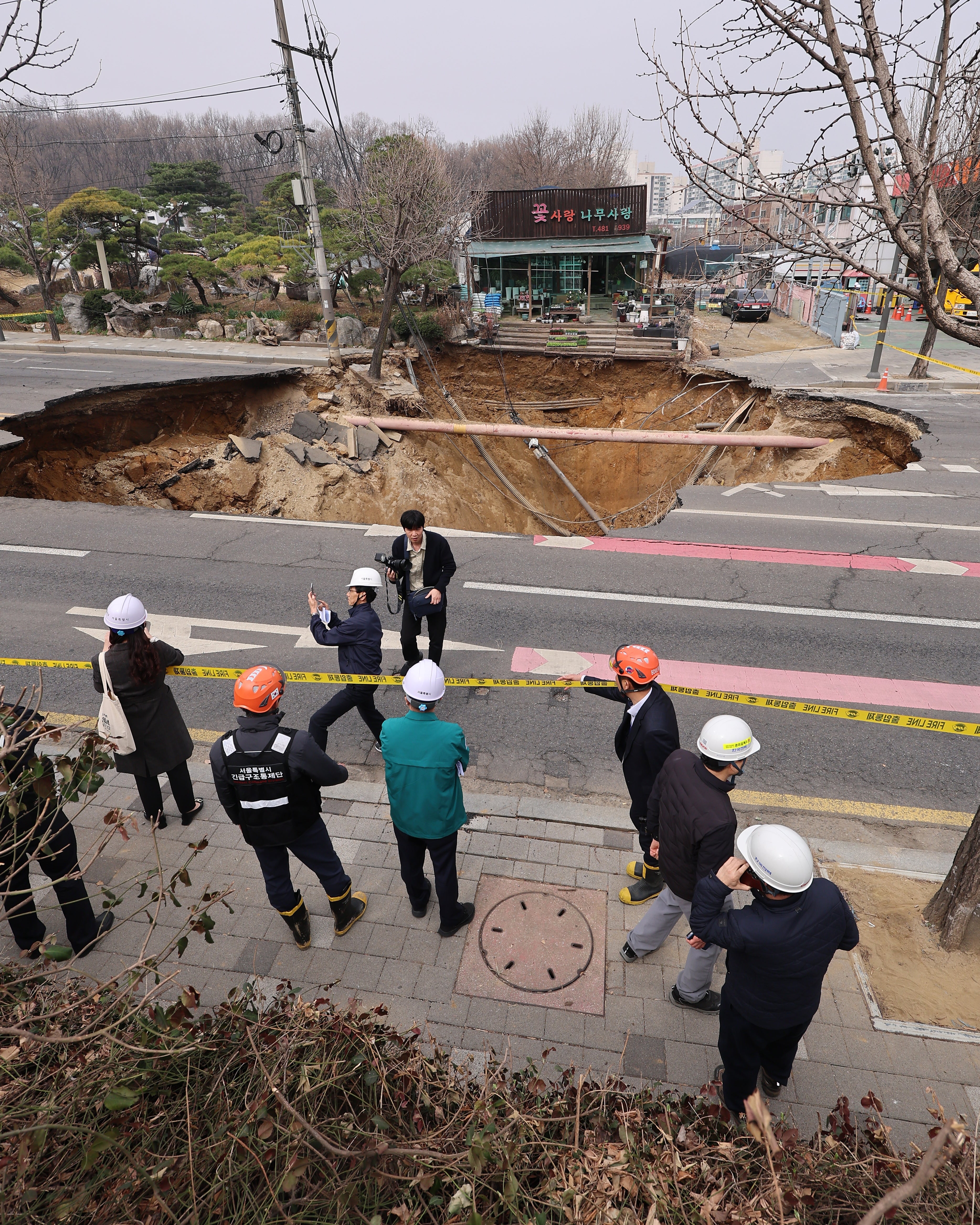 Site of a sinkhole, 20m-wide and 18m-deep, at an intersection in Gangdong Ward, Seoul on 25 March 2025
