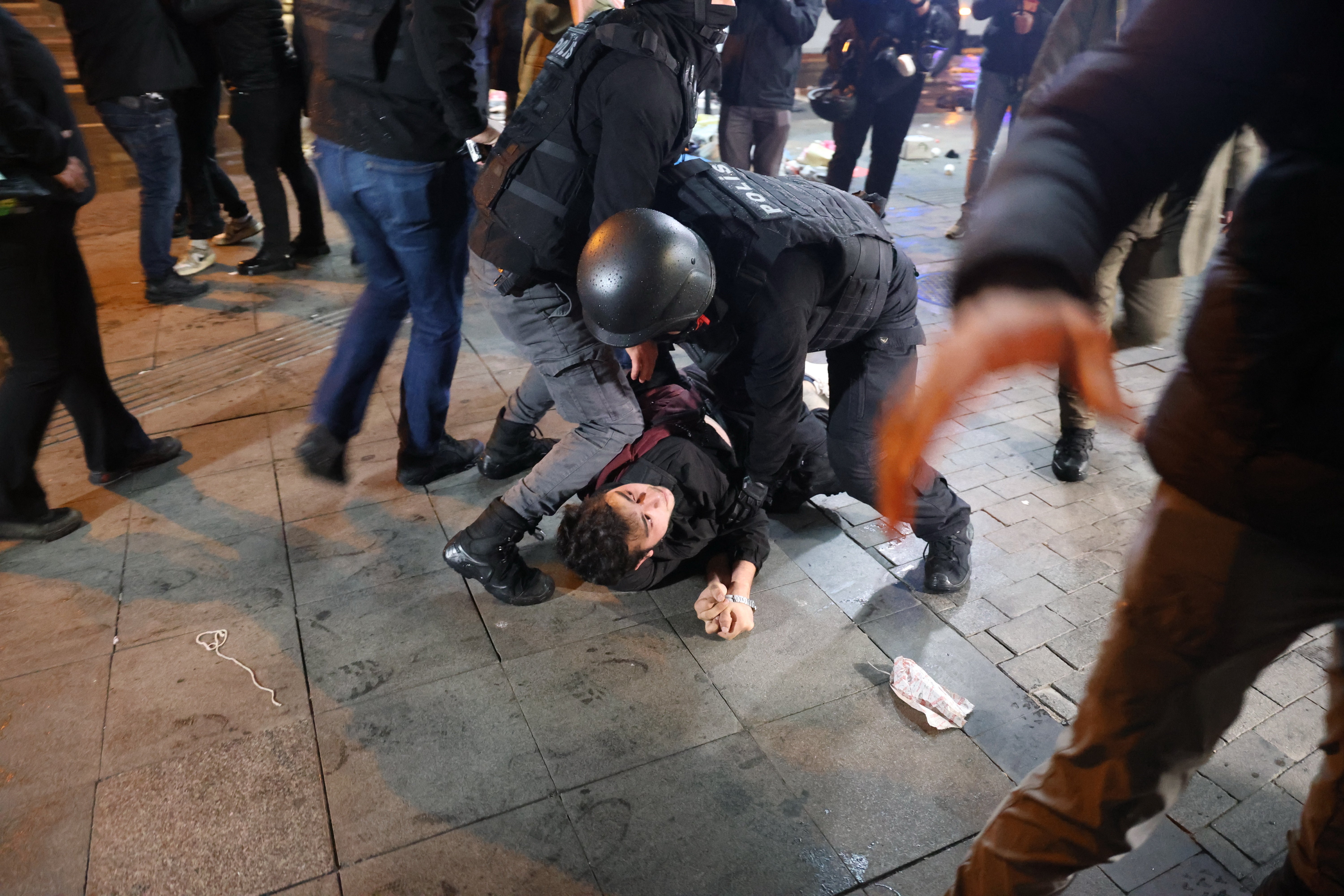 Riot police detain a protester in Ankara