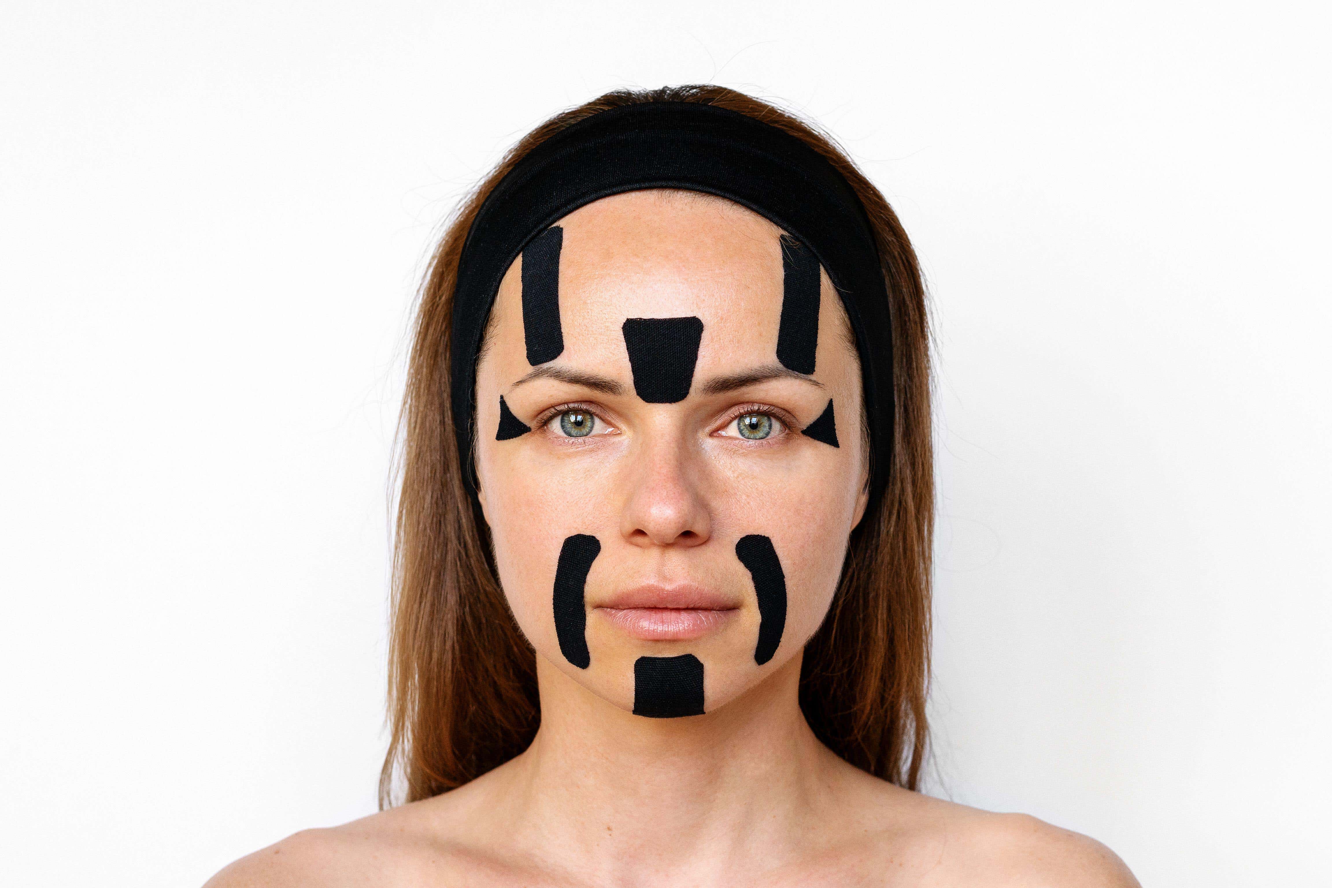 Facial taping involves placing tape in certain places to restrict the movement of the skin