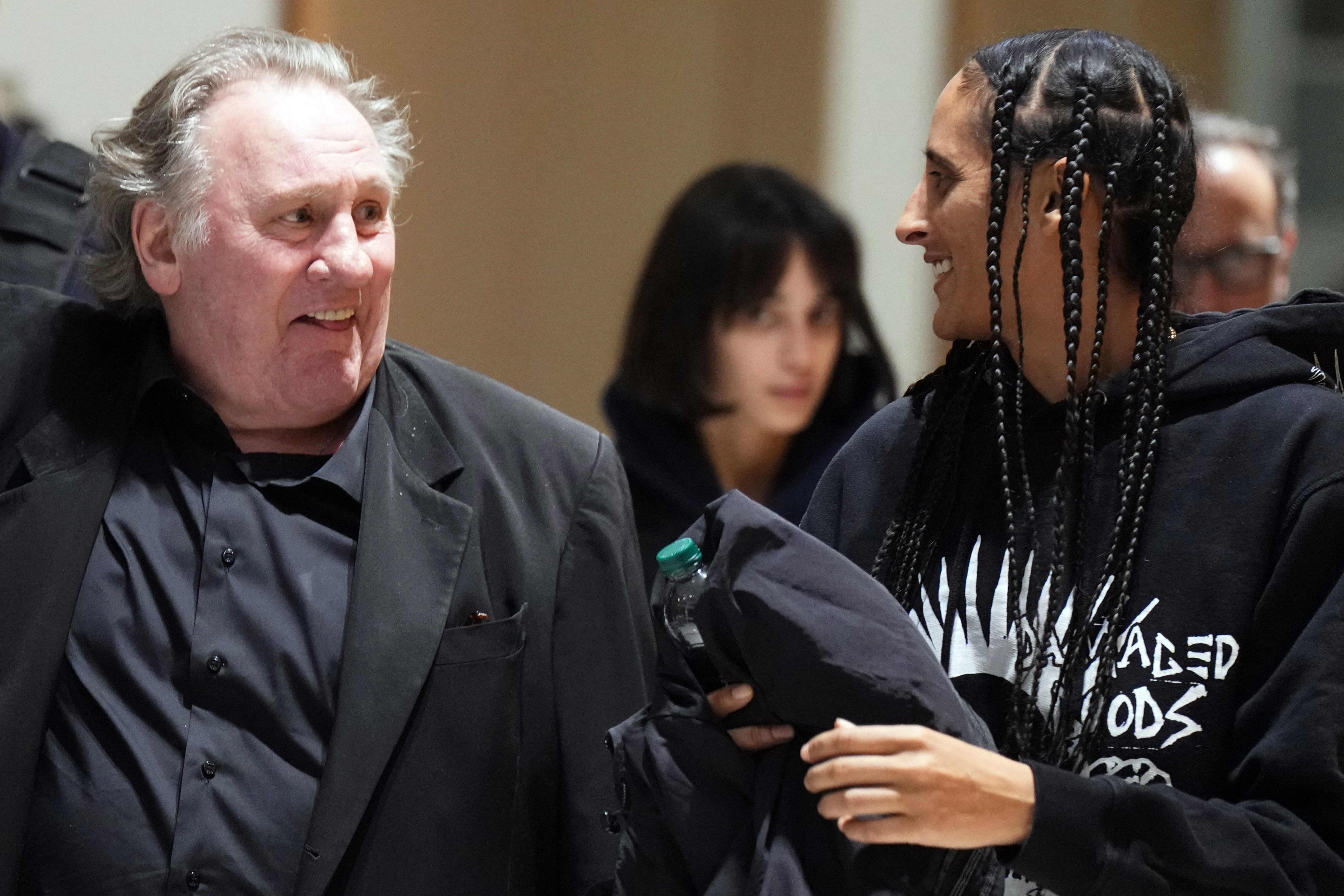 French actor Gerard Depardieu (L) leaves with his daughter after a hearing