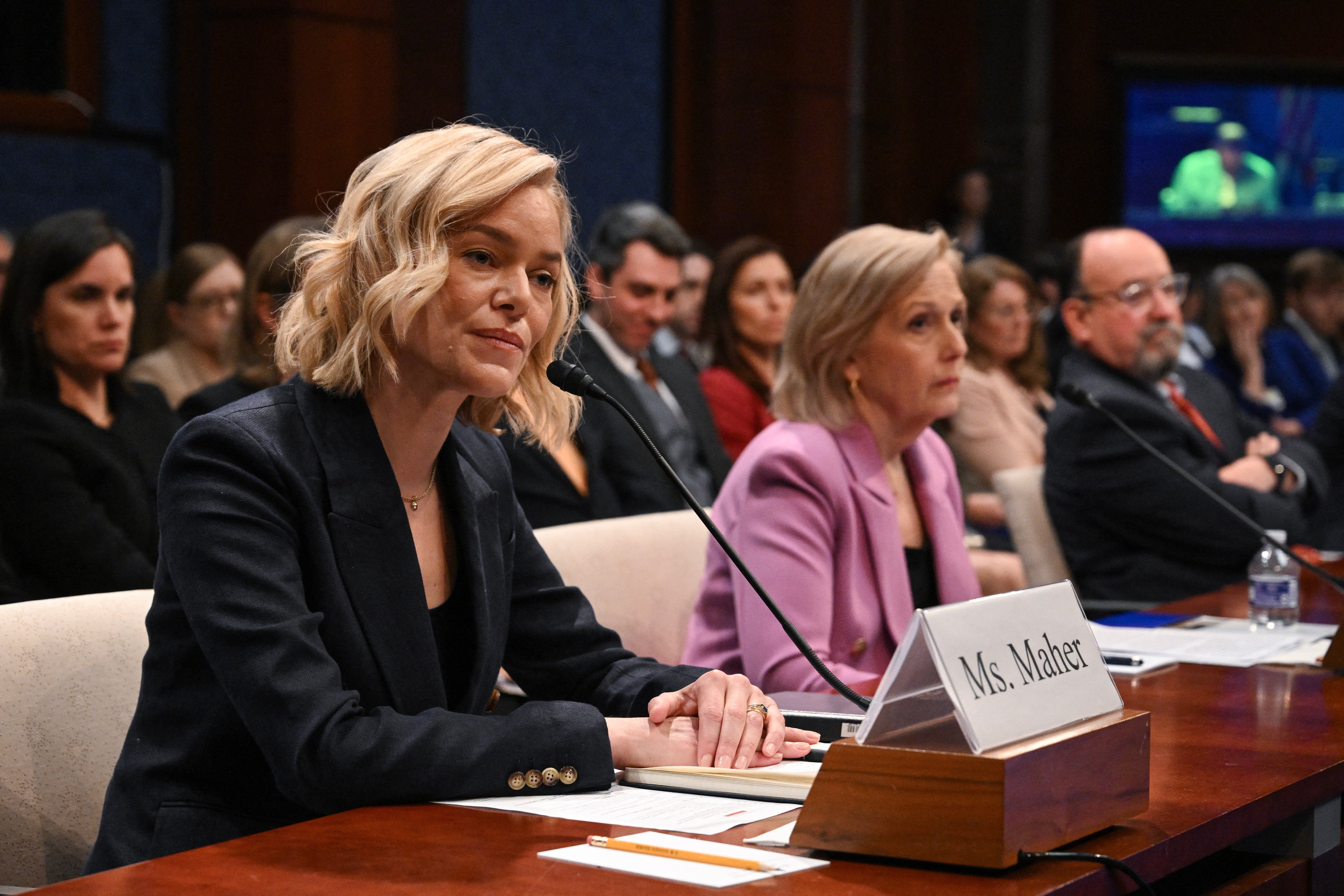 NPR CEO Katherine Maher, left, and PBS CEO Paula Kerger, center, testified to House lawmakers March 26 as Republicans threaten to defund their organizations, which could imperil local networks that rely on federal support