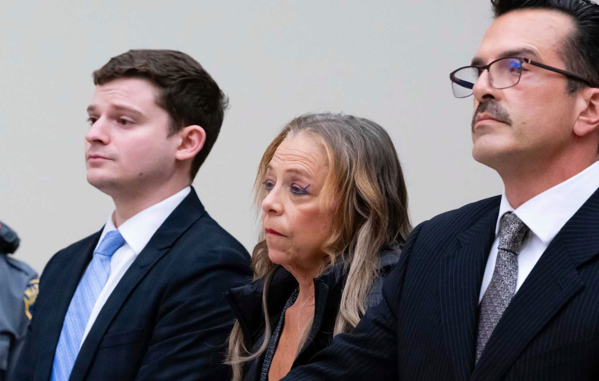 Kim Sullivan who is charged with neglect, stands between her attorneys Jason Spilka, left, and Ioannis Kaloidis, right, during her arraignment Wednesday, March 12, 2025 at Waterbury Superior Court in Waterbury, Conn. (Jim Shannon/Hearst Connecticut Media via AP, Pool)