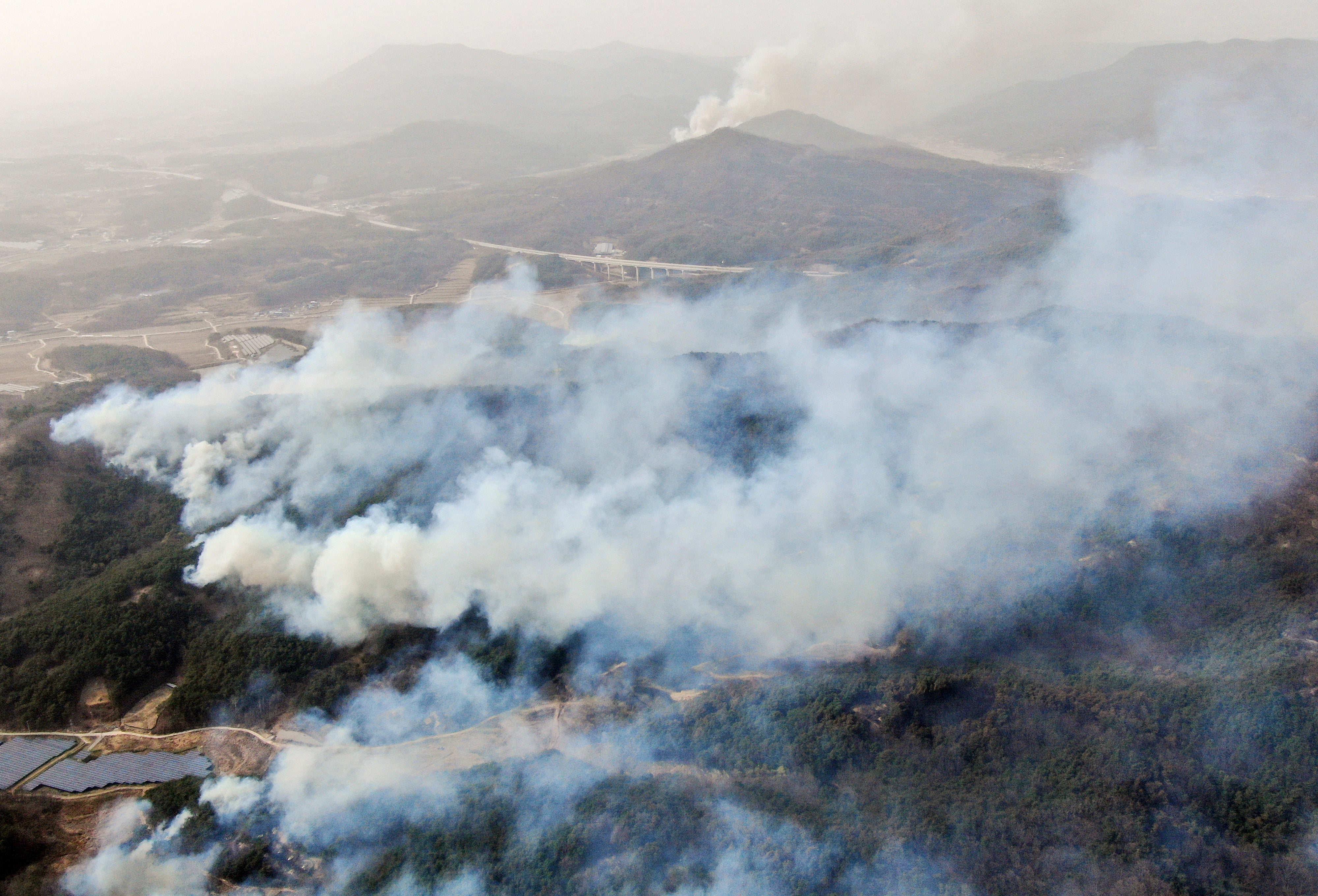 Smoke rises from a mountain in Andong, South Korea