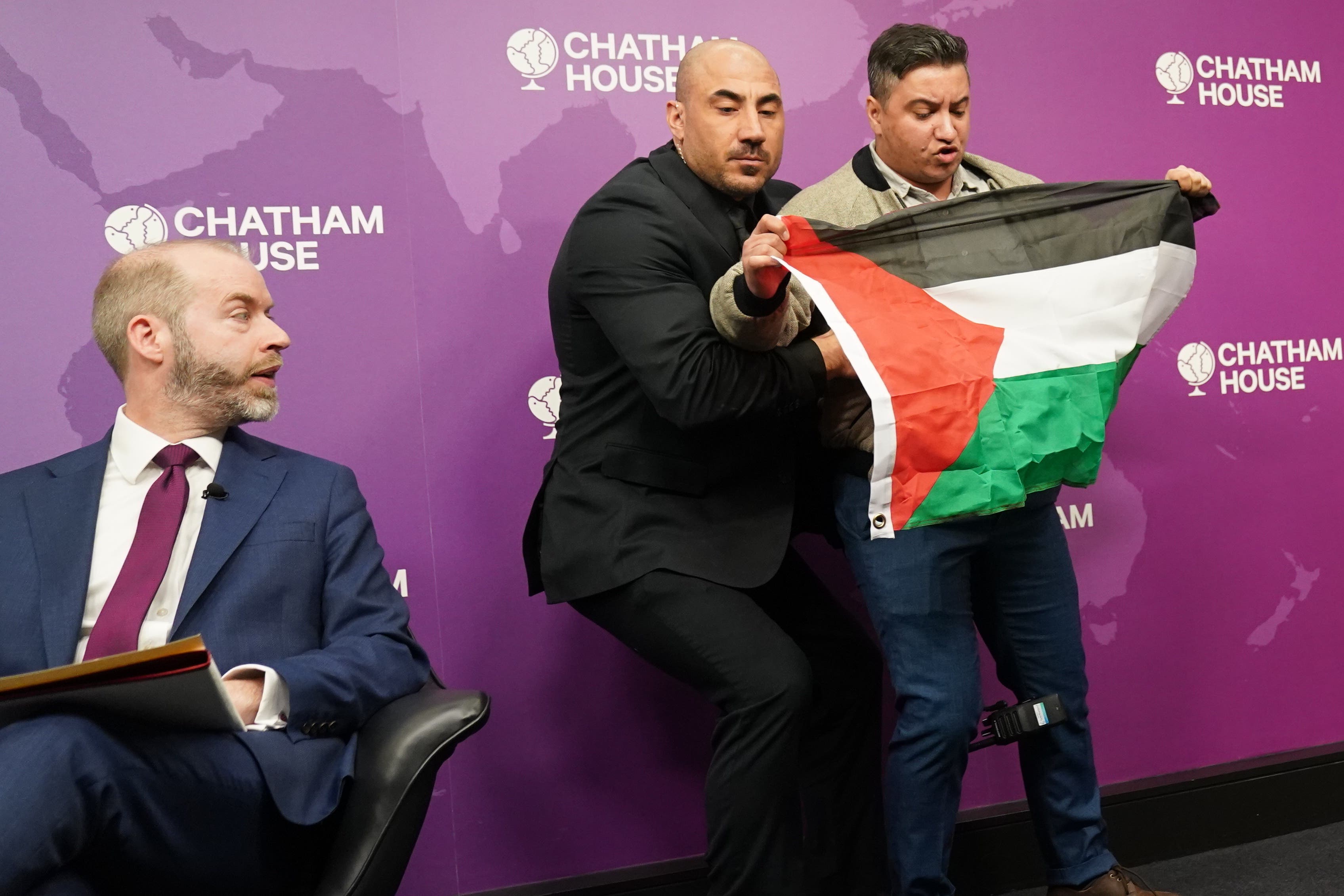 A protester interrupts Business Secretary Jonathan Reynolds delivering his speech at Chatham House (Stefan Rousseau/PA)