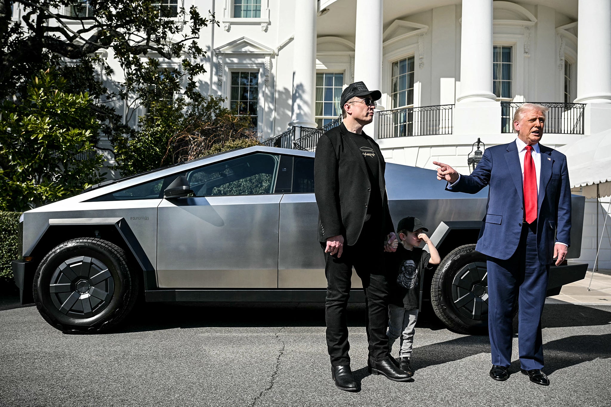 <p>Donald Trump and Elon Musk speak to the press as they stand next to a Tesla Cybertruck at the White House</p>