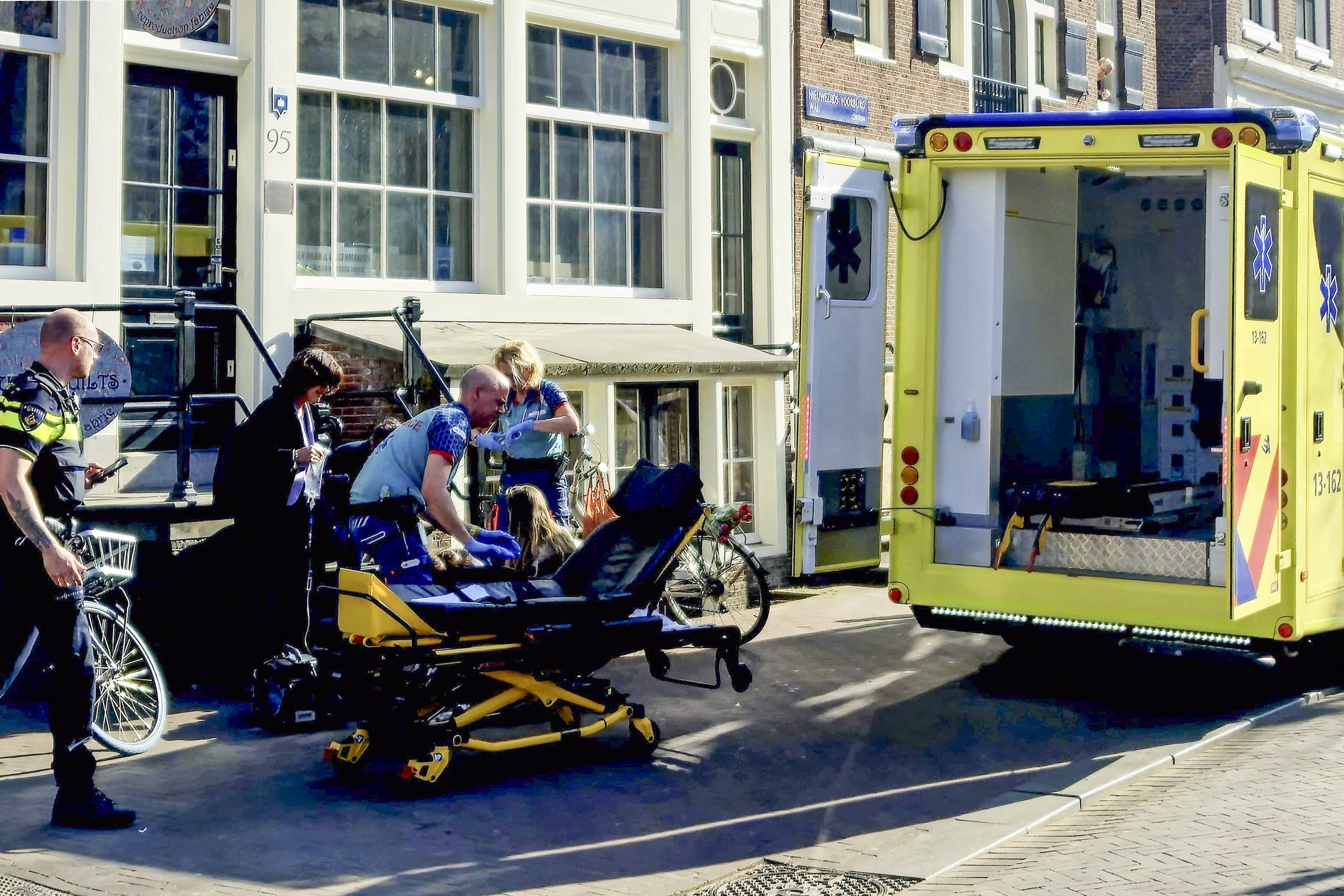 Medical staff assist one of the five person that were wounded during a stabbing attack in Amsterdam