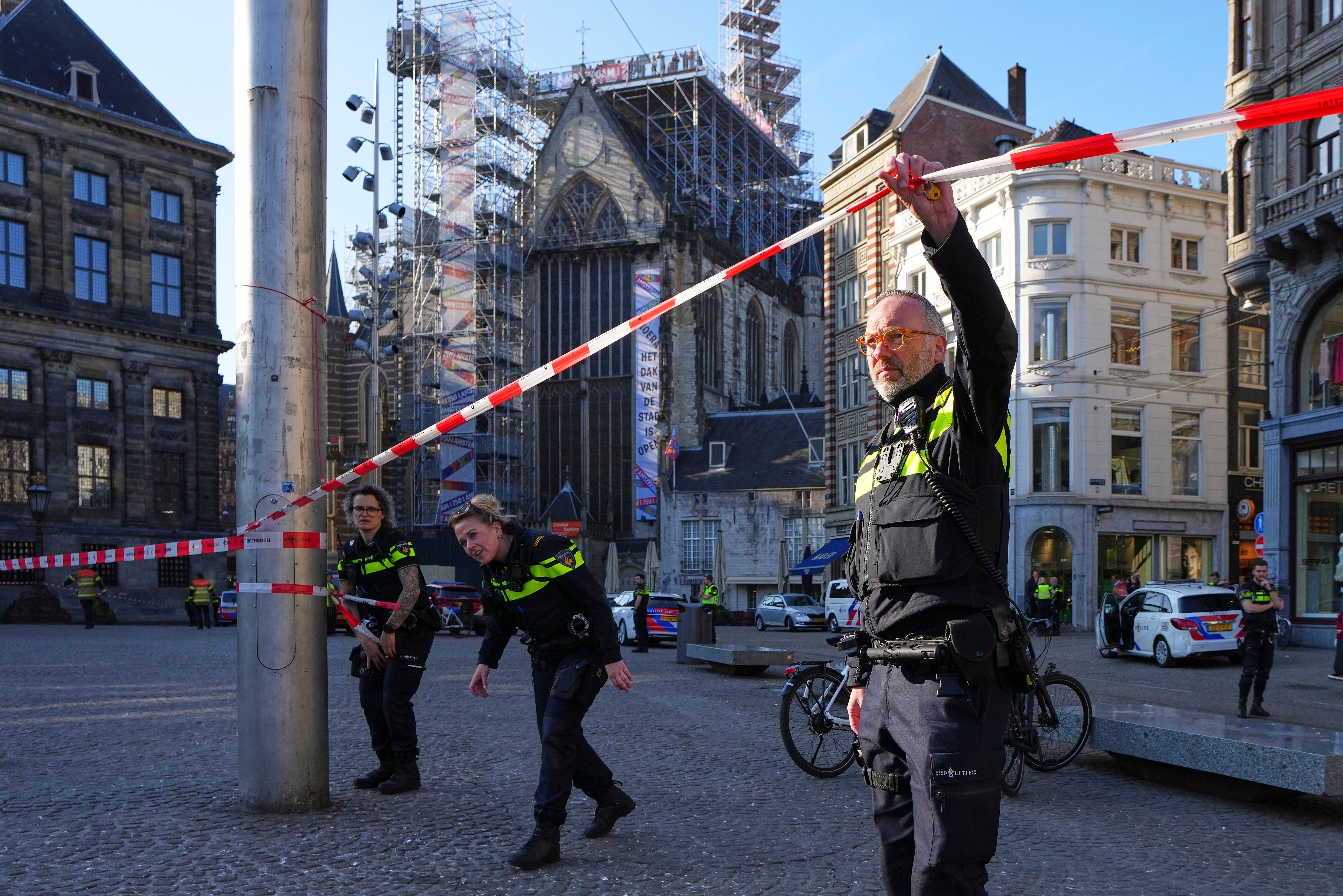 Police officers cordon-off an area after a stabbing near Dam Square in central Amsterdam