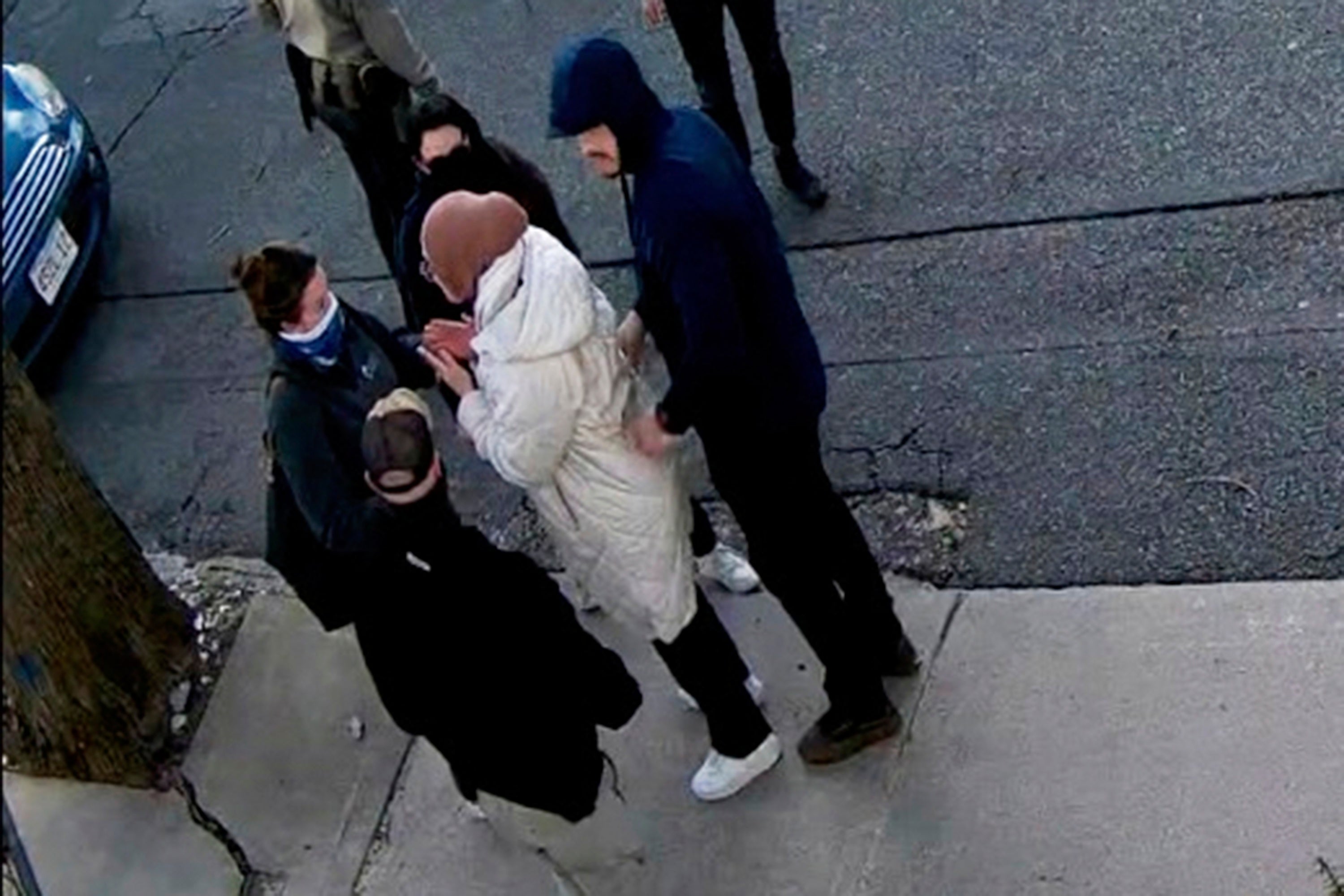 Surveillance camera footage of Ozturk’s arrest on March 25 shows several plain-clothes federal agents surrounding her on the sidewalk near her home in Massachusetts