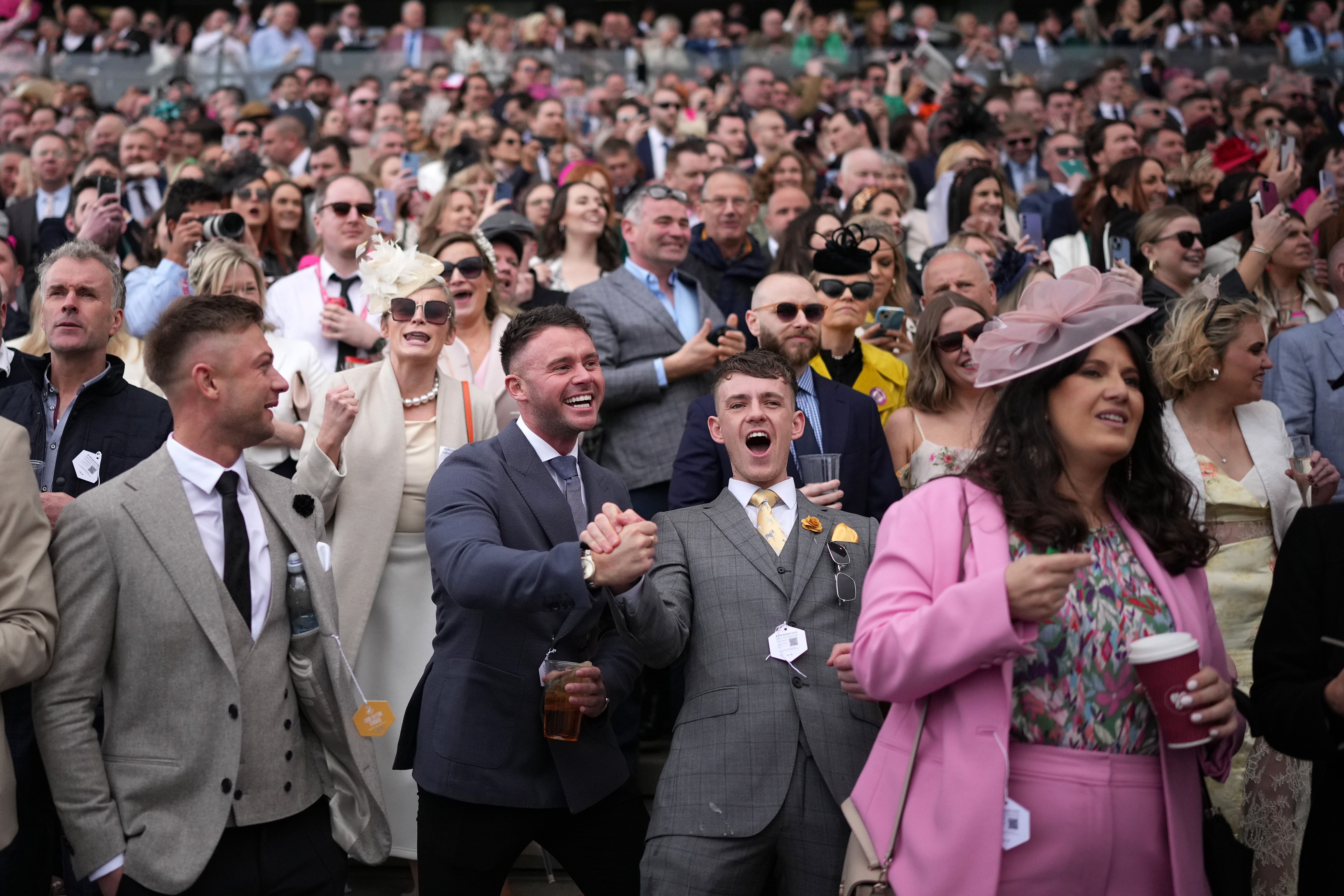 Racegoers cheer as Jockey Paul Townend wins the 2024 Grand National riding I Am Maximus
