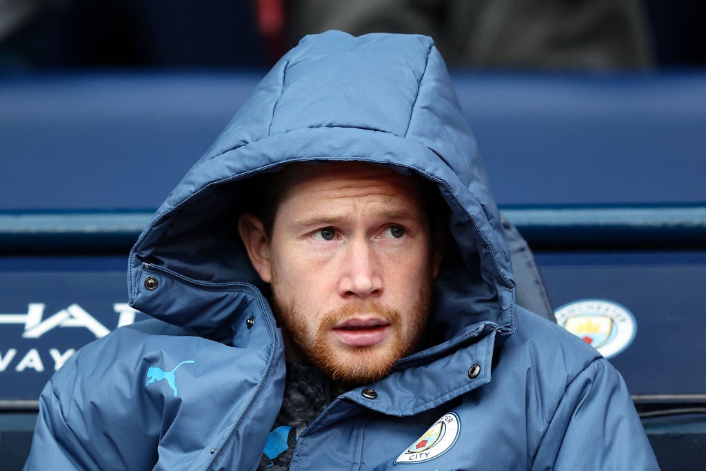 Kevin De Bruyne looks on from the substitutes bench during a Premier League match