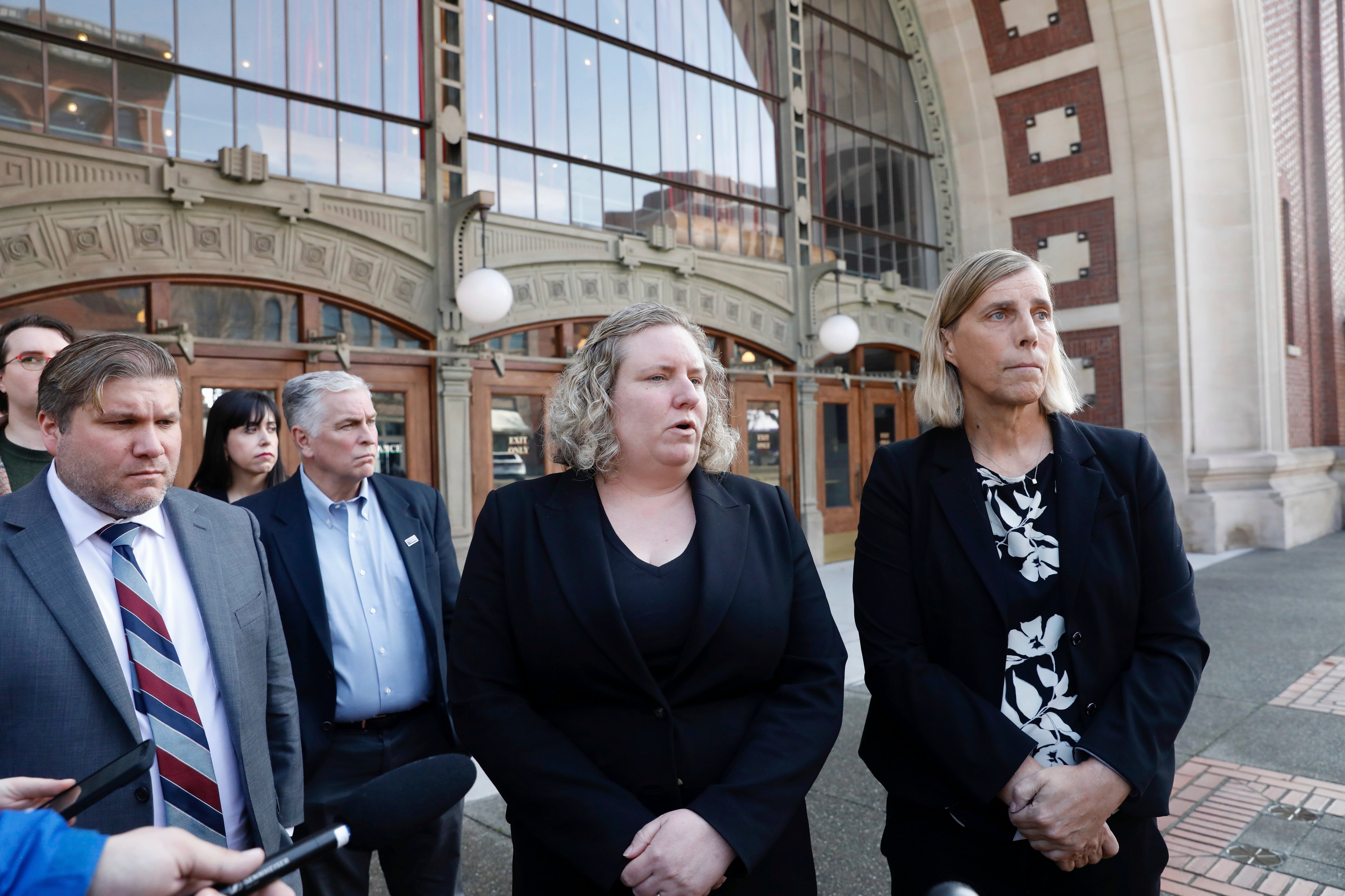 Human Rights Campaign legal director Sarah Warbelow, center, and Lamda Legal counsel Sasha Buchert, right, speak to reporters outside federal court in Washington March 25