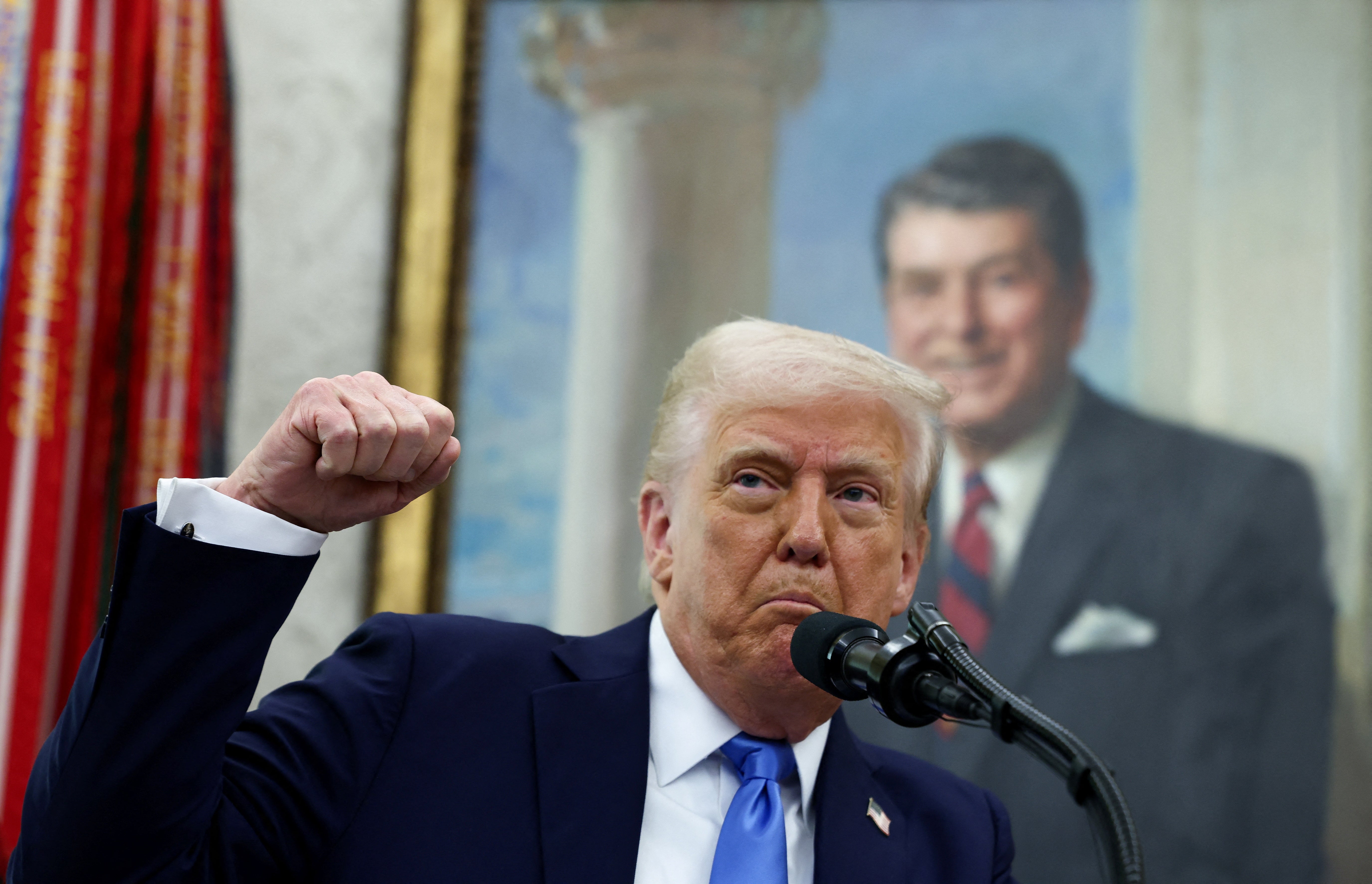 President Donald Trump speaks in the Oval Office beneath a portrait of Ronald Reagan, an advocate of free trade who spoke out against tariffs