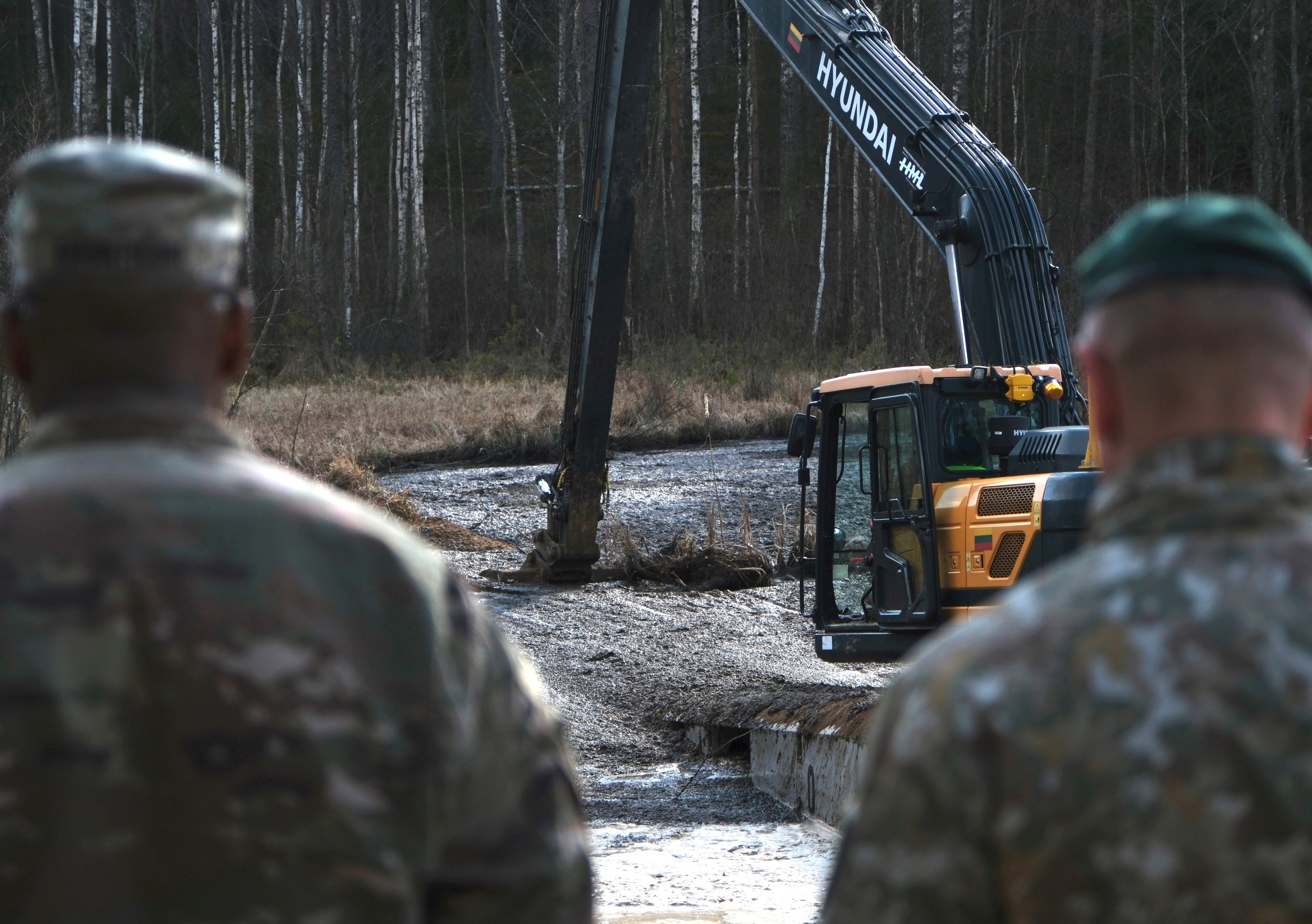U.S. Army soldiers along with Lithuanian Army and emergency services personnel discuss their plan to recover the soldiers near Pabadre, Lithuania