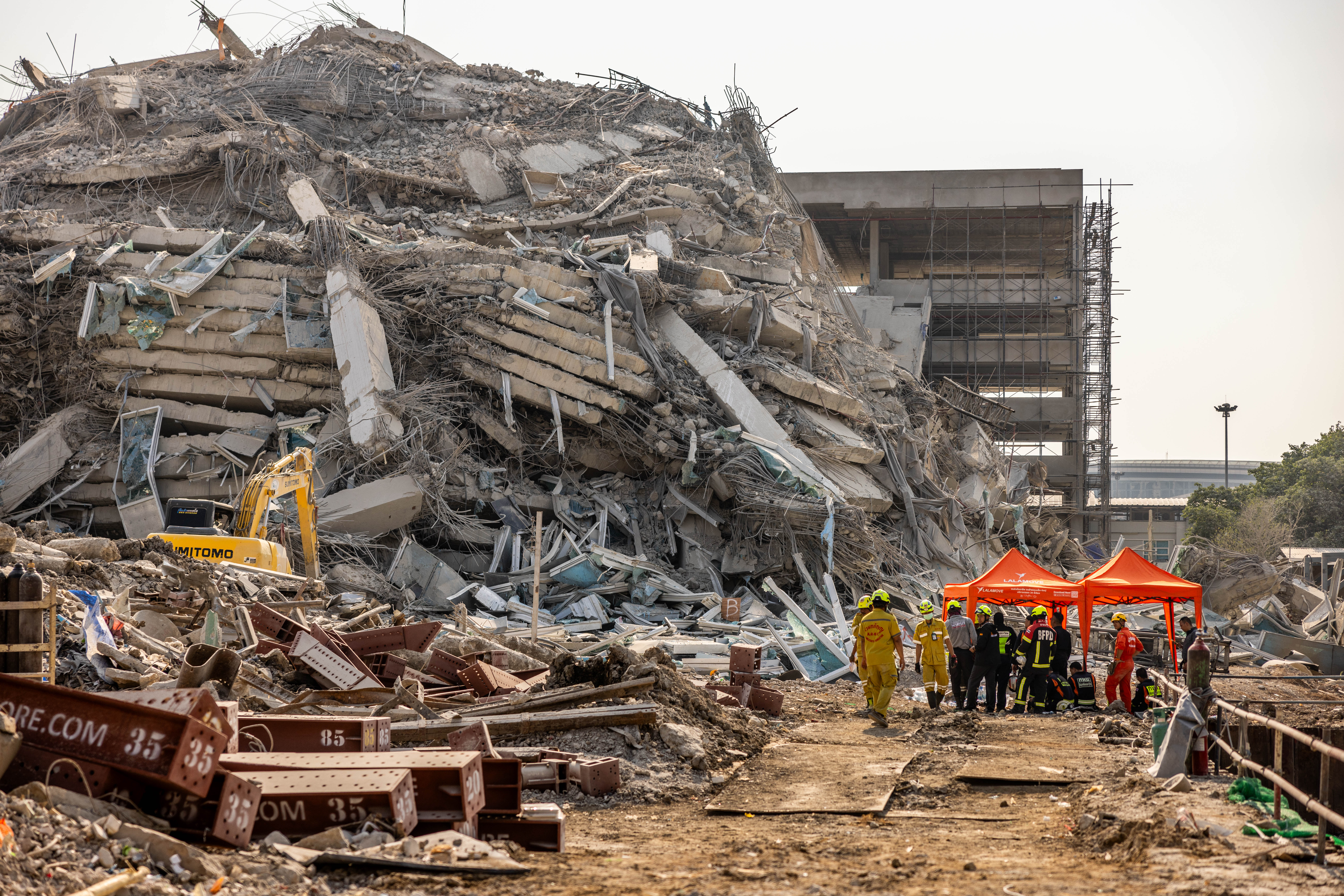 Thai rescue workers arrive on scene at a construction building collapse in the Chatuchak area following the earthquake in Bangkok, Thailand, on Friday
