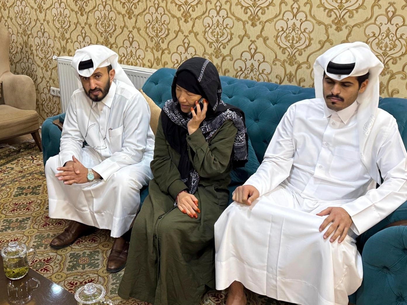 In this undated handout photo released by the Qatar Ministry of Foreign Affairs, American Faye Dail Hall, center, is pictured with diplomat Mirdef Alqashouti, of the Qatar Embassy in Afghanistan, left, after Dail was released Thursday, March 27, 2025, by the Taliban in Kabul, Afghanistan. (Qatar Ministry of Foreign Affairs via AP)