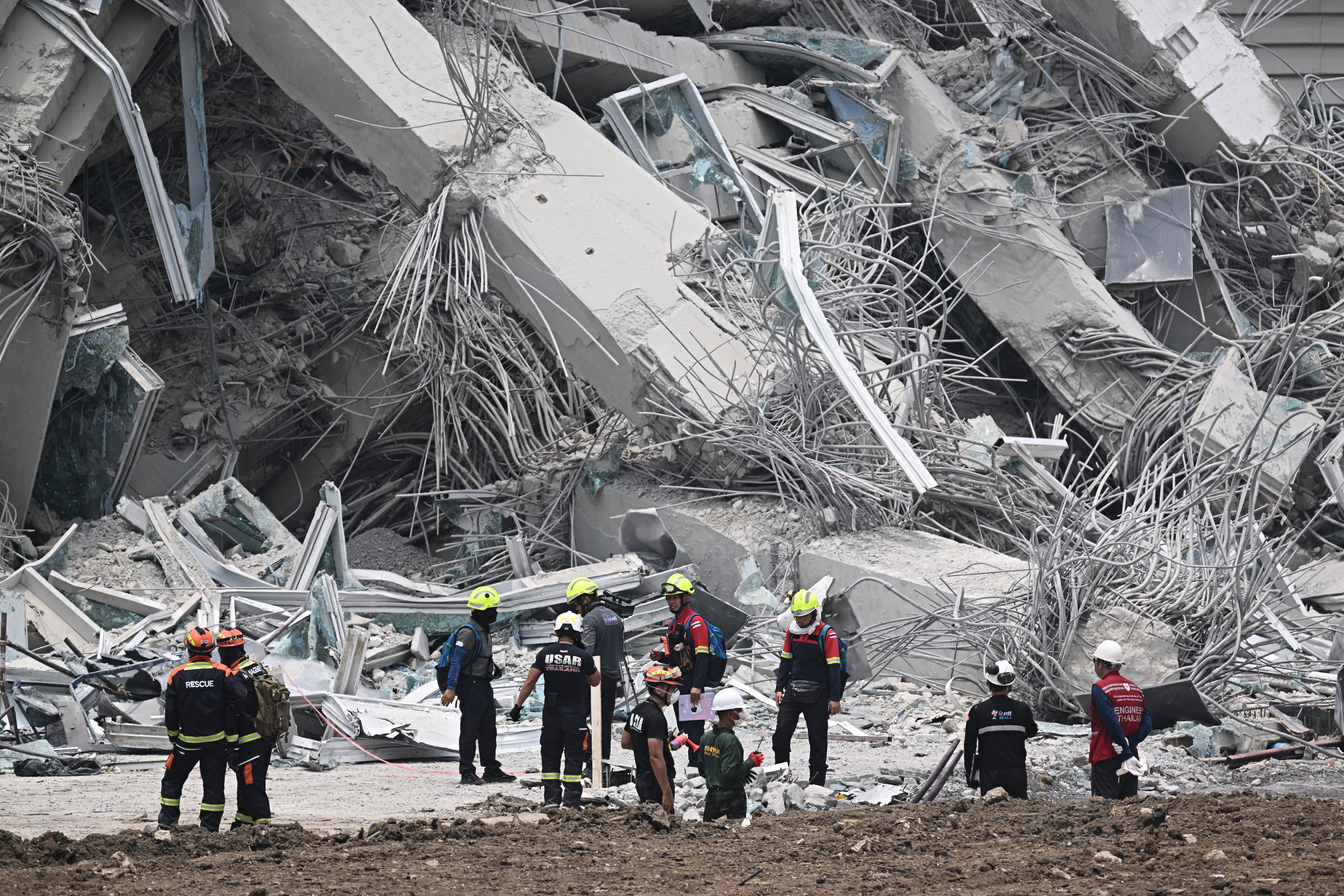 Rescue workers survey the site of an under-construction building collapse in Bangkok.