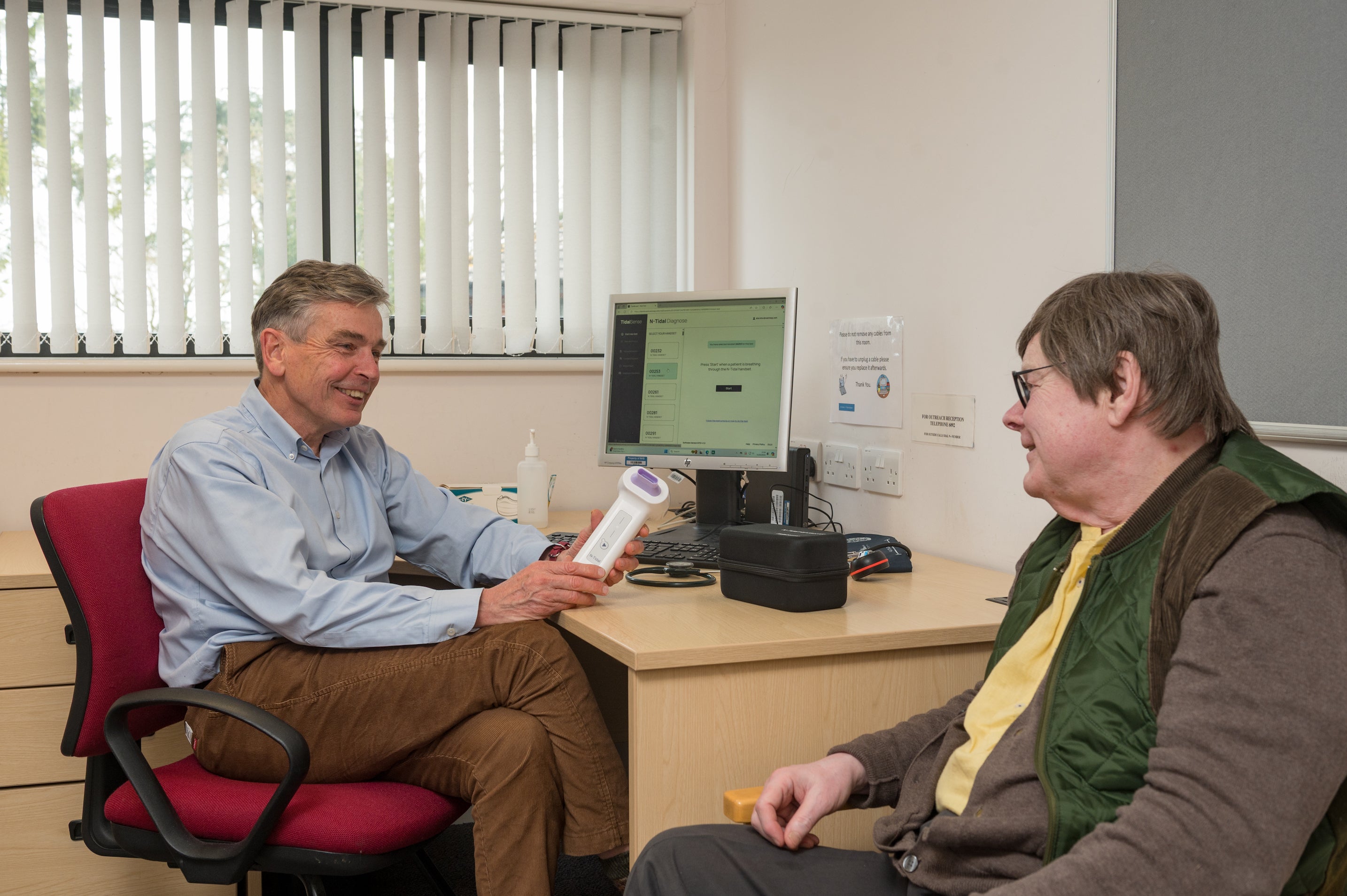 Dr Simon Rudland, a GP in Suffolk, showing the N-Tidal Diagnose test to a patient