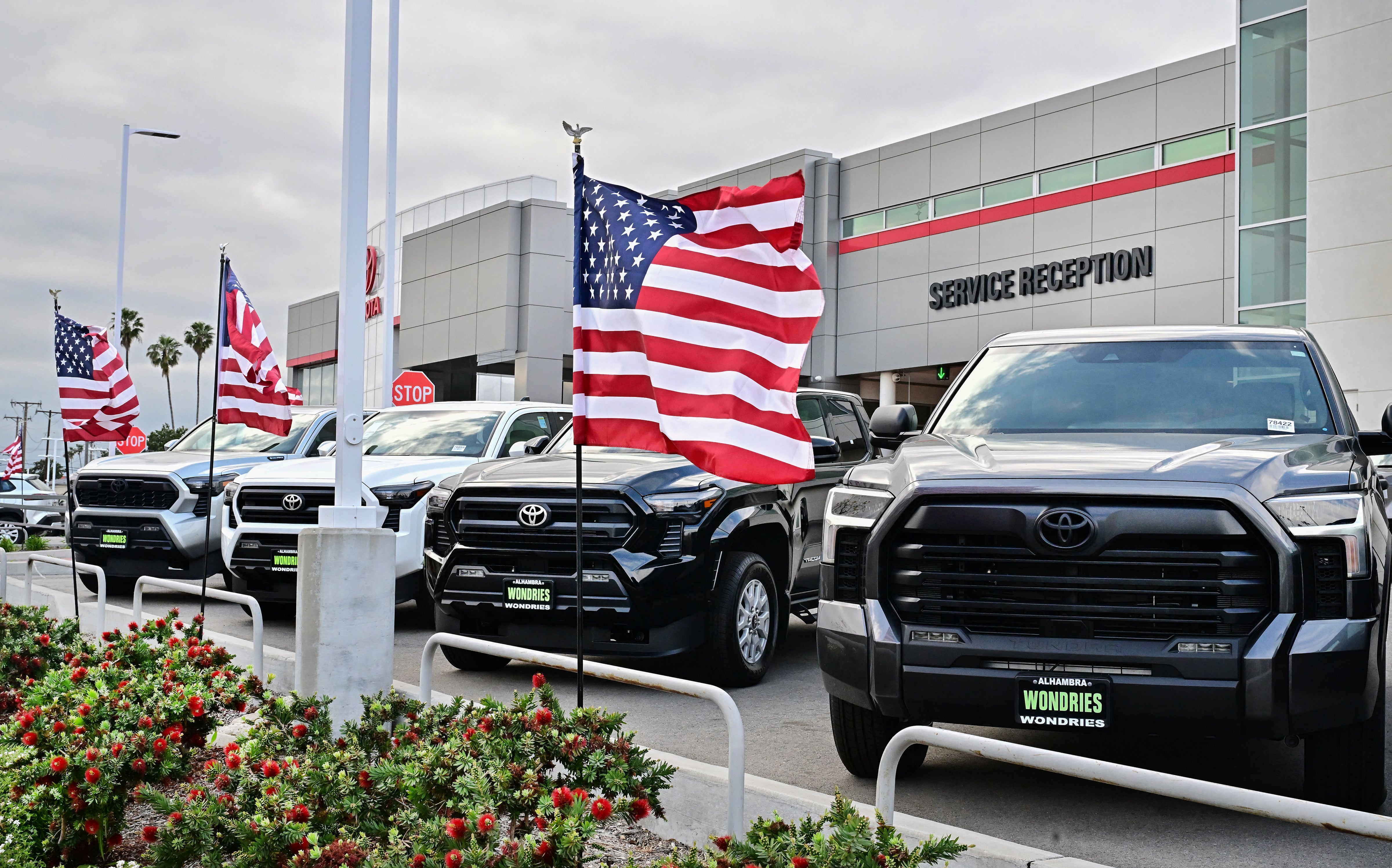 US flags fly outside a Toyota dealership in Alhambra, California