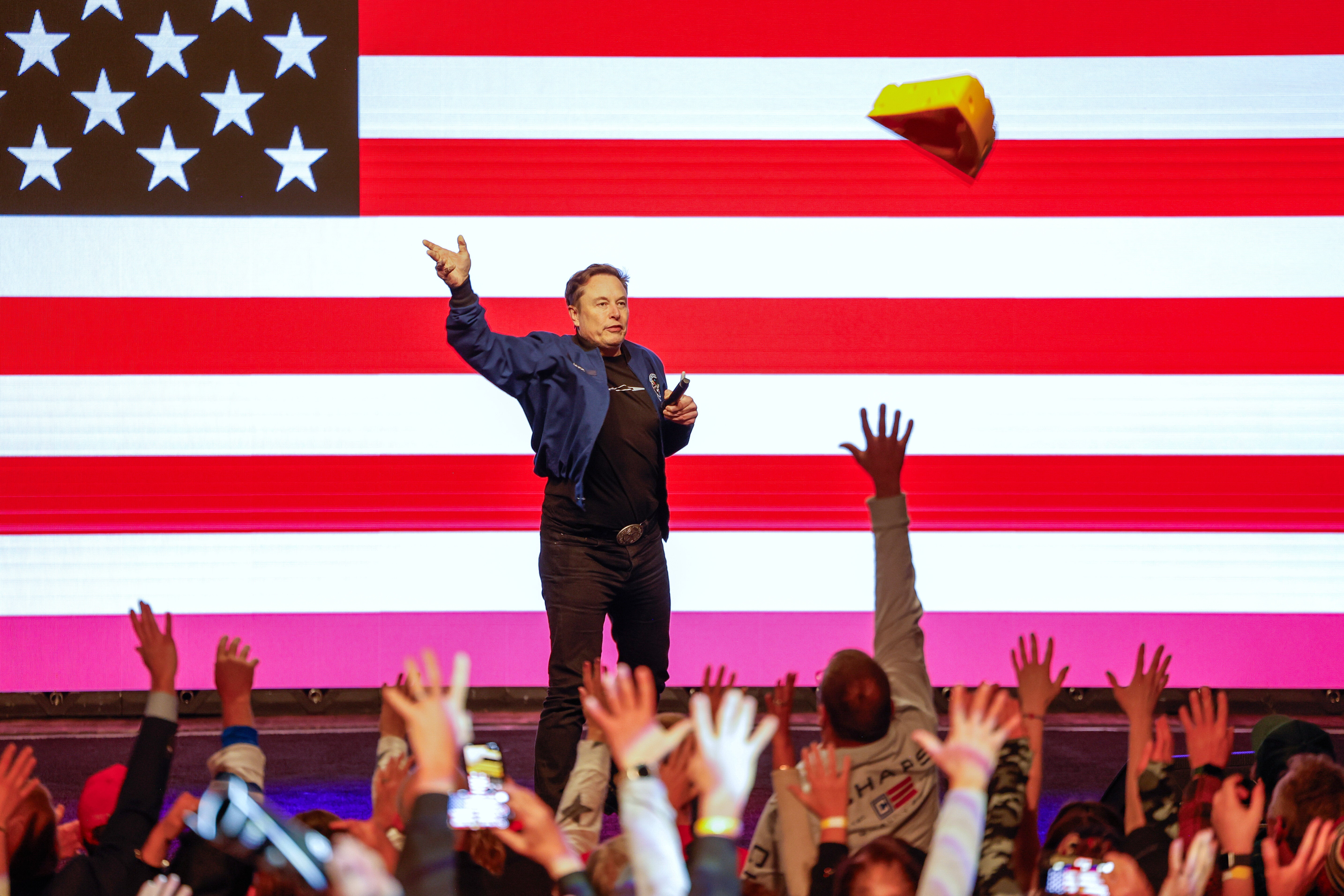 Elon Musk tosses a cheesehead during a town hall Sunday, March 30, 2025, in Green Bay, Wis.