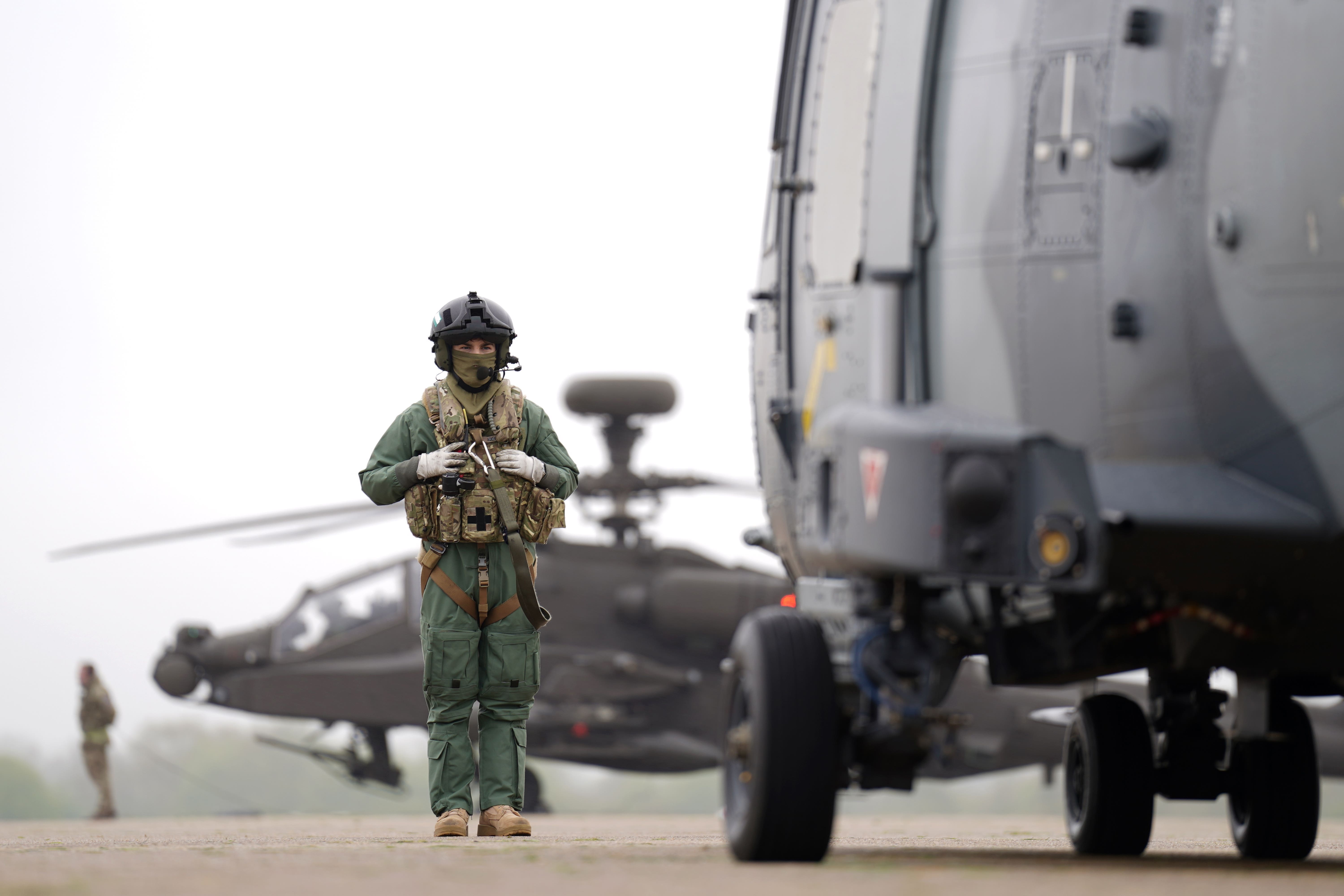 British Army Apache AH-64E attack helicopters are prepared for take off from Wattisham Flying Station in Suffolk alongside Wildcat (Joe Giddens/PA)