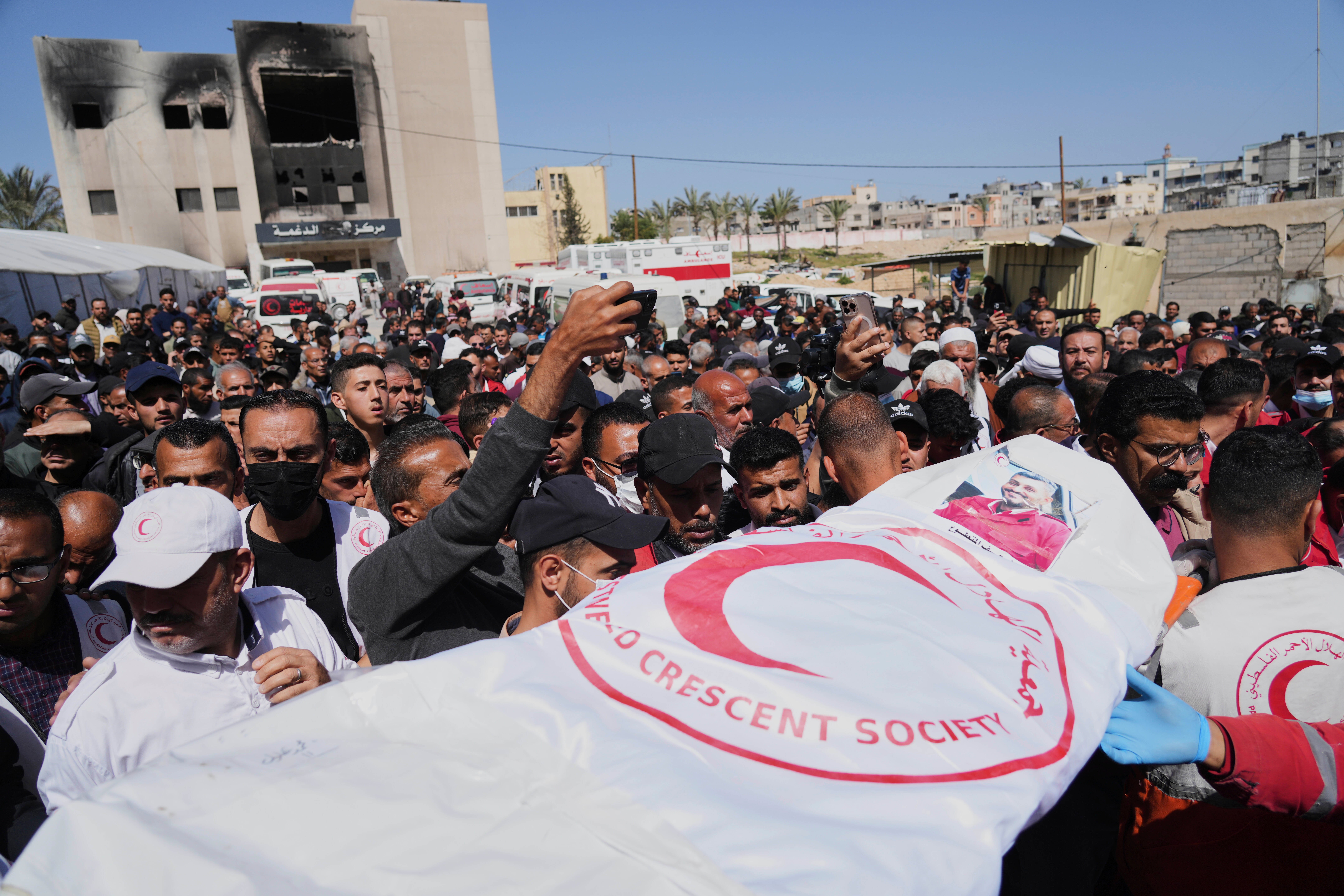On Monday, the UN said Israel killed 15 more medical and emergency workers as they attempted to rescue the injured from the southern city of Rafah. Pictured: funeral of one of the ICRC workers