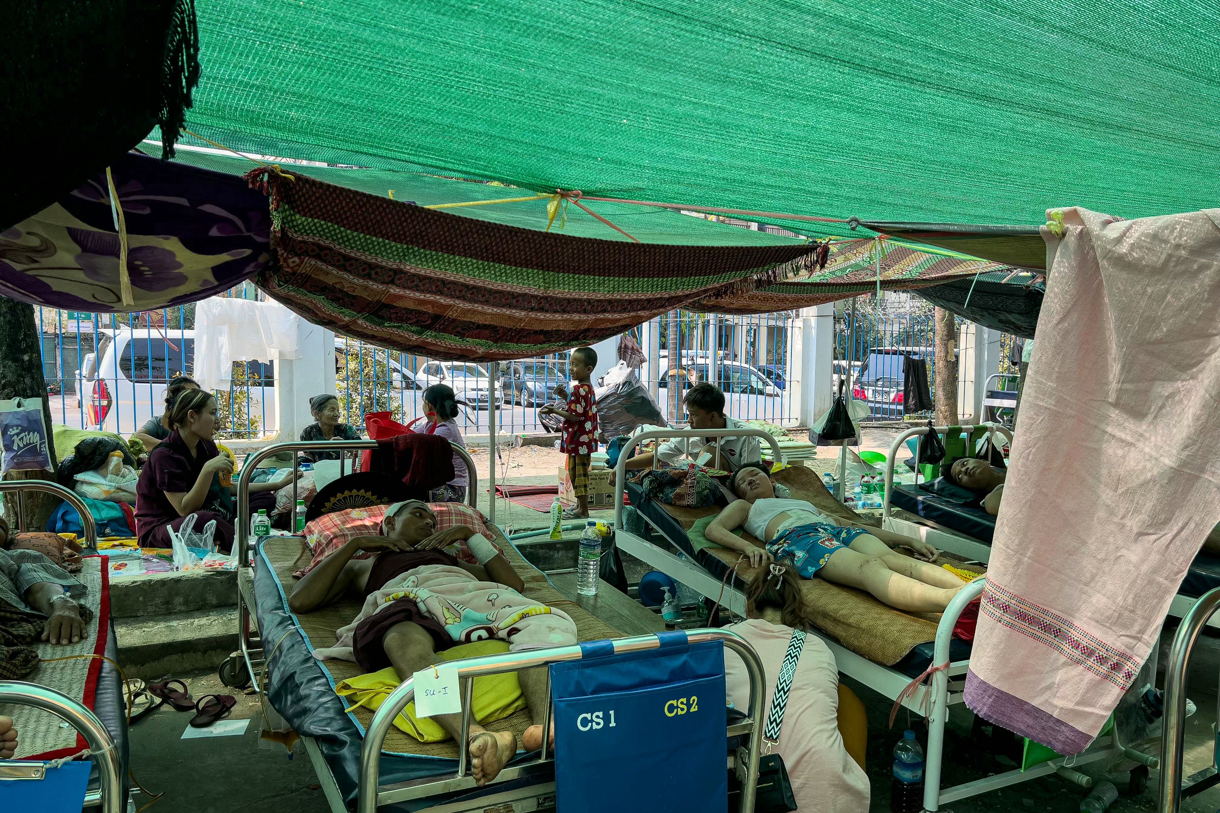 Patients lie on beds in the compound of Mandalay General Hospital in Mandalay on Monday, three days after the deadly Myanmar earthquake