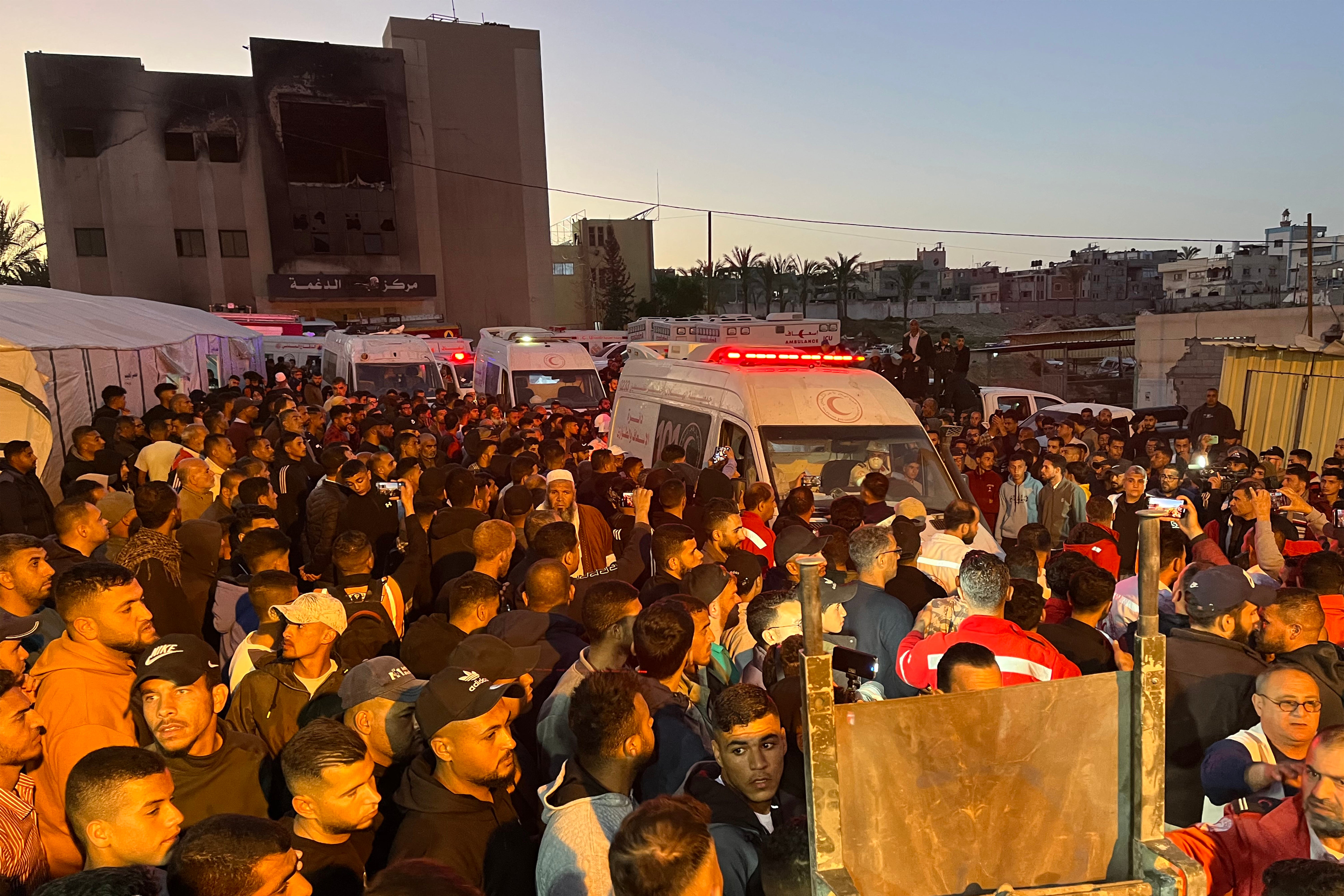 Ambulances carrying the bodies of Palestinian first responders who were killed a week before in Israeli military fire on other ambulance vehicles arrive at Nasser Medical Complex in Khan Yunis in the southern Gaza Strip on Sunday