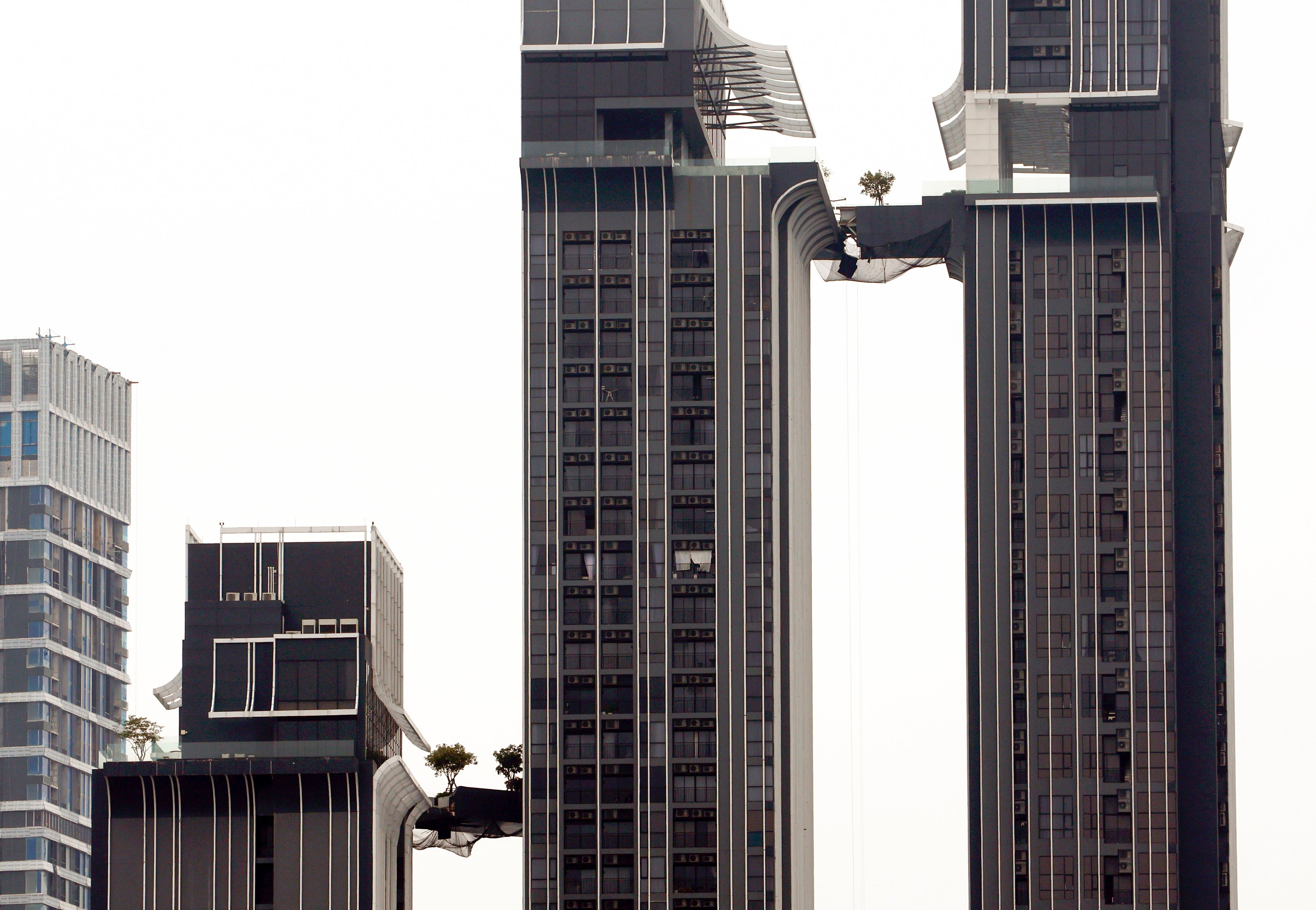 Damaged sky bridge walkways connecting high rise buildings of a luxury residential condominium in Bangkok, Thailand, 31 March