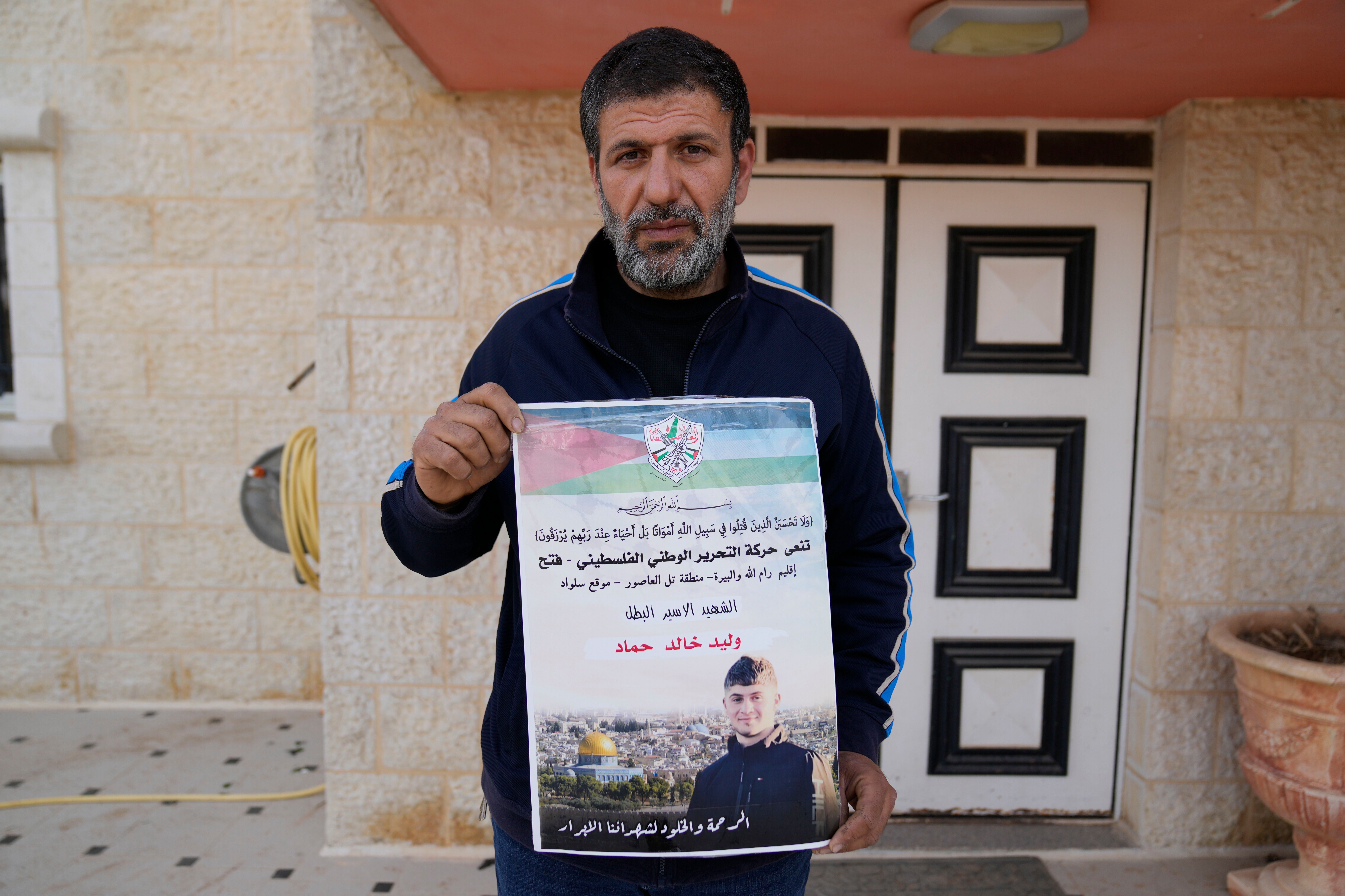 Khalid Ahmad holds a poster of Waleed, 17 who died in an Israeli prison