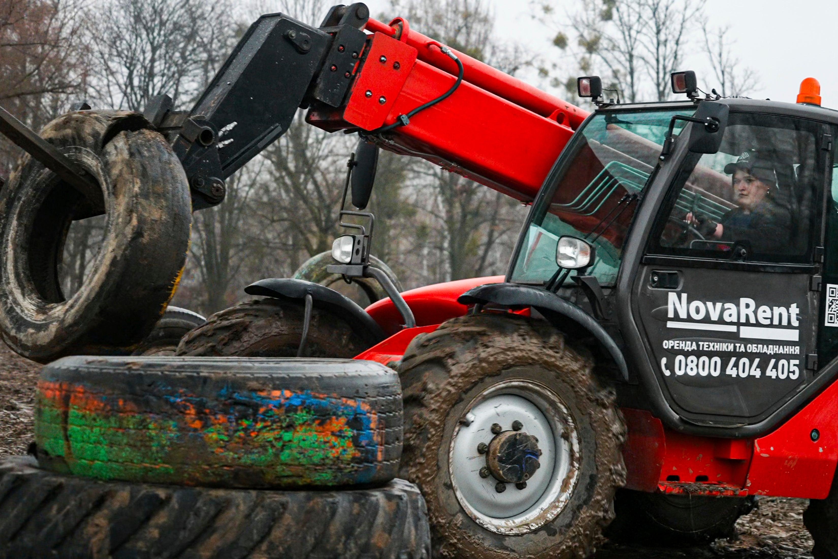 Student Kateryna Koliadiuk drives a tractor in Nemishaieve, Kyiv region