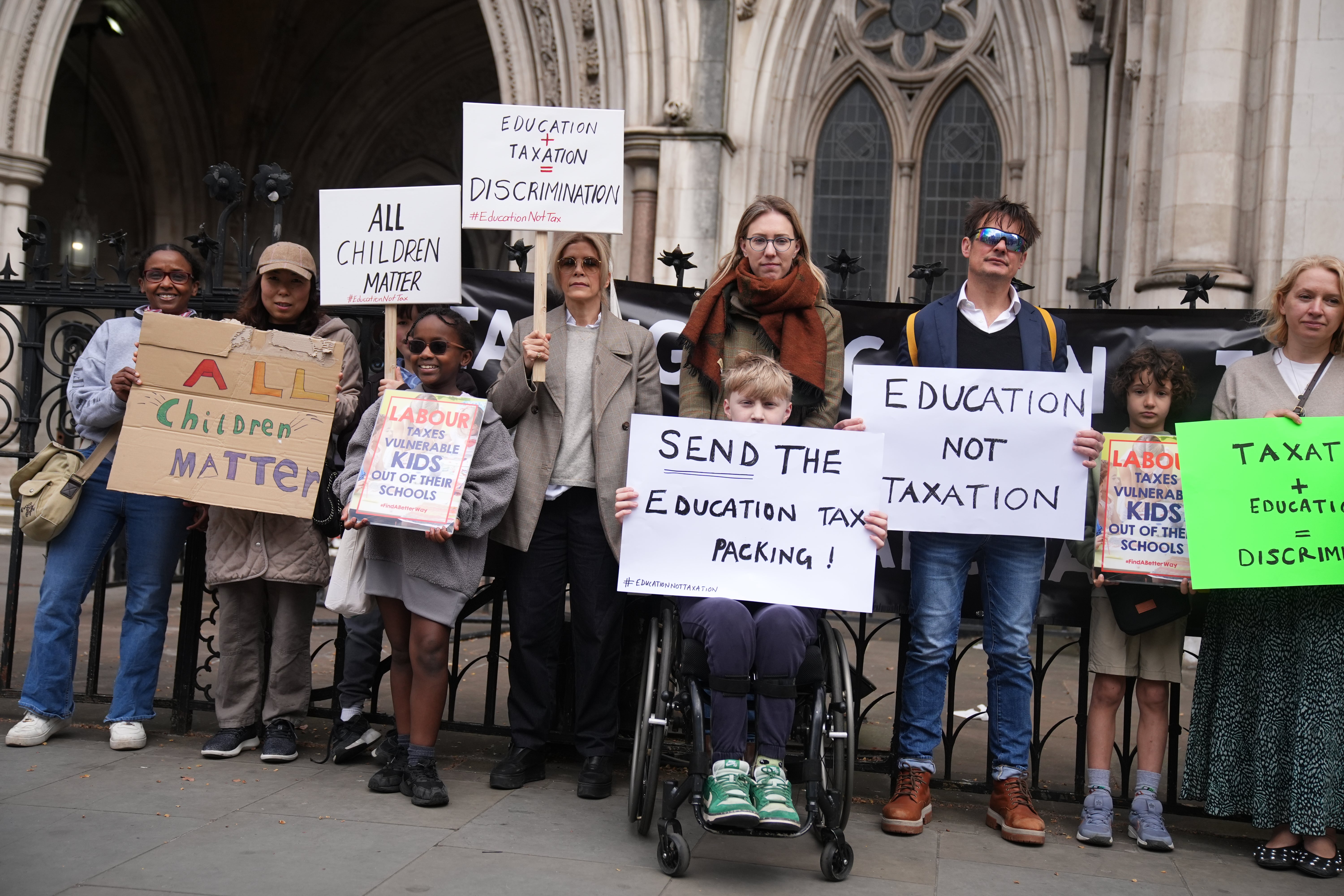 Families protested outside the Royal Courts of Justice ahead of a discrimination case against the government