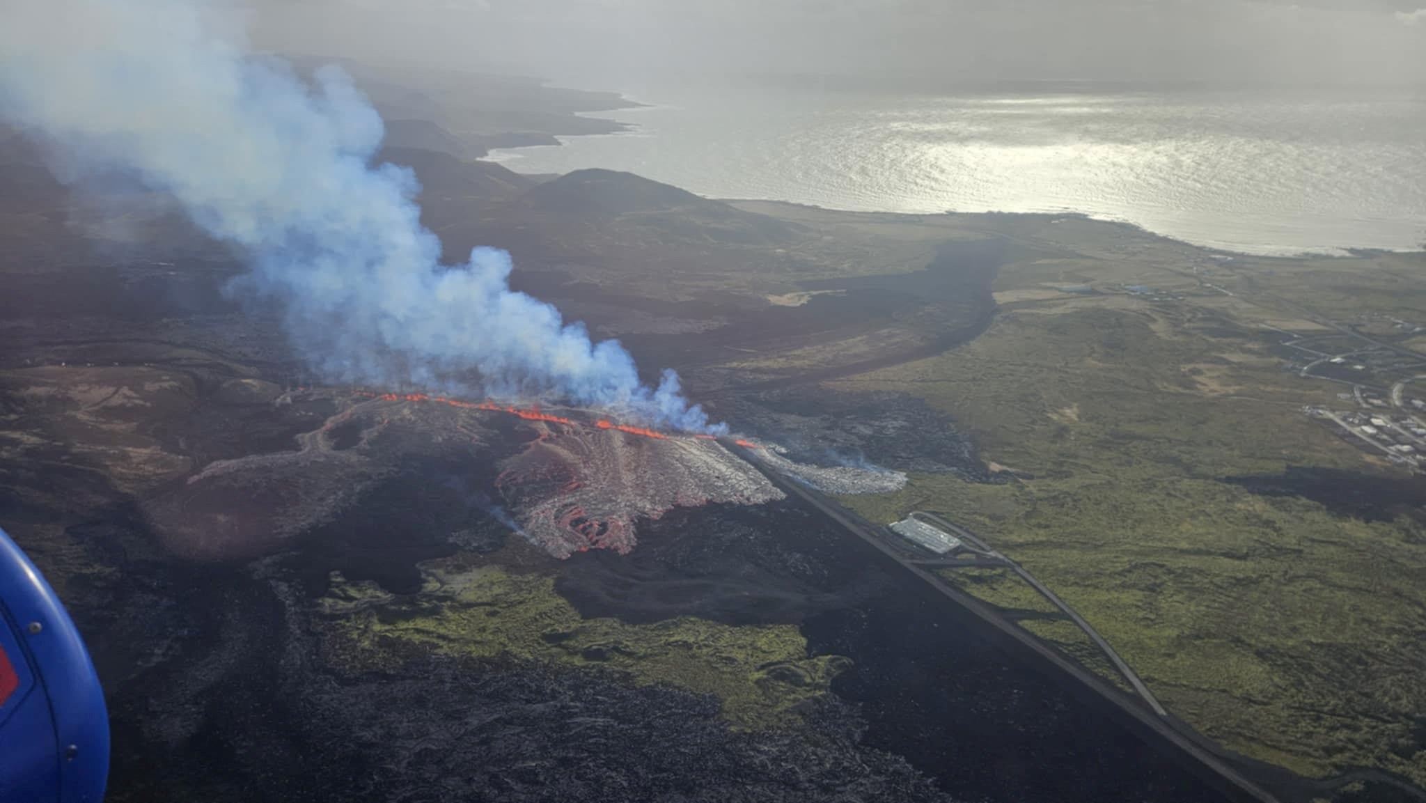 Smoke billows as the volcano erupts near Grindavik