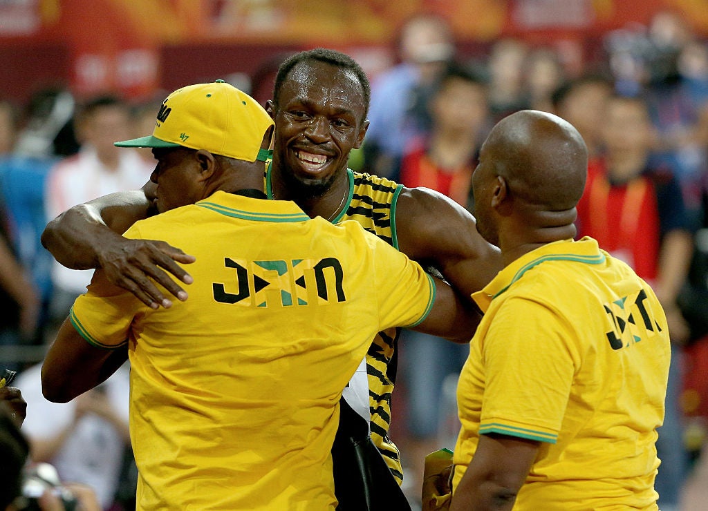 Bolt celebrated with his father (left) after winning gold in the 100m at the World Athletics Championships in 2015