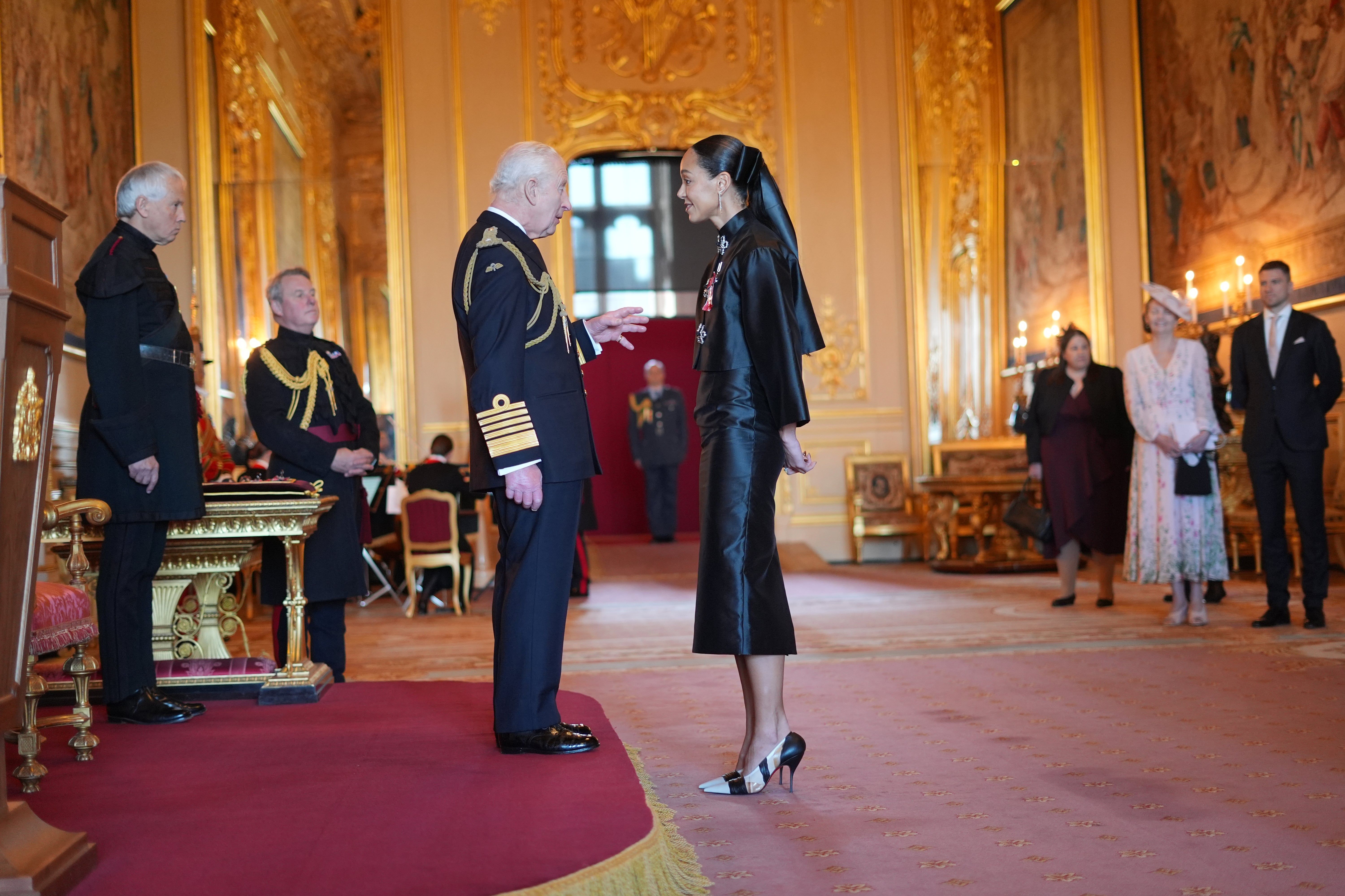 The King speaks to Katarina Johnson-Thompson at her investiture as an MBE